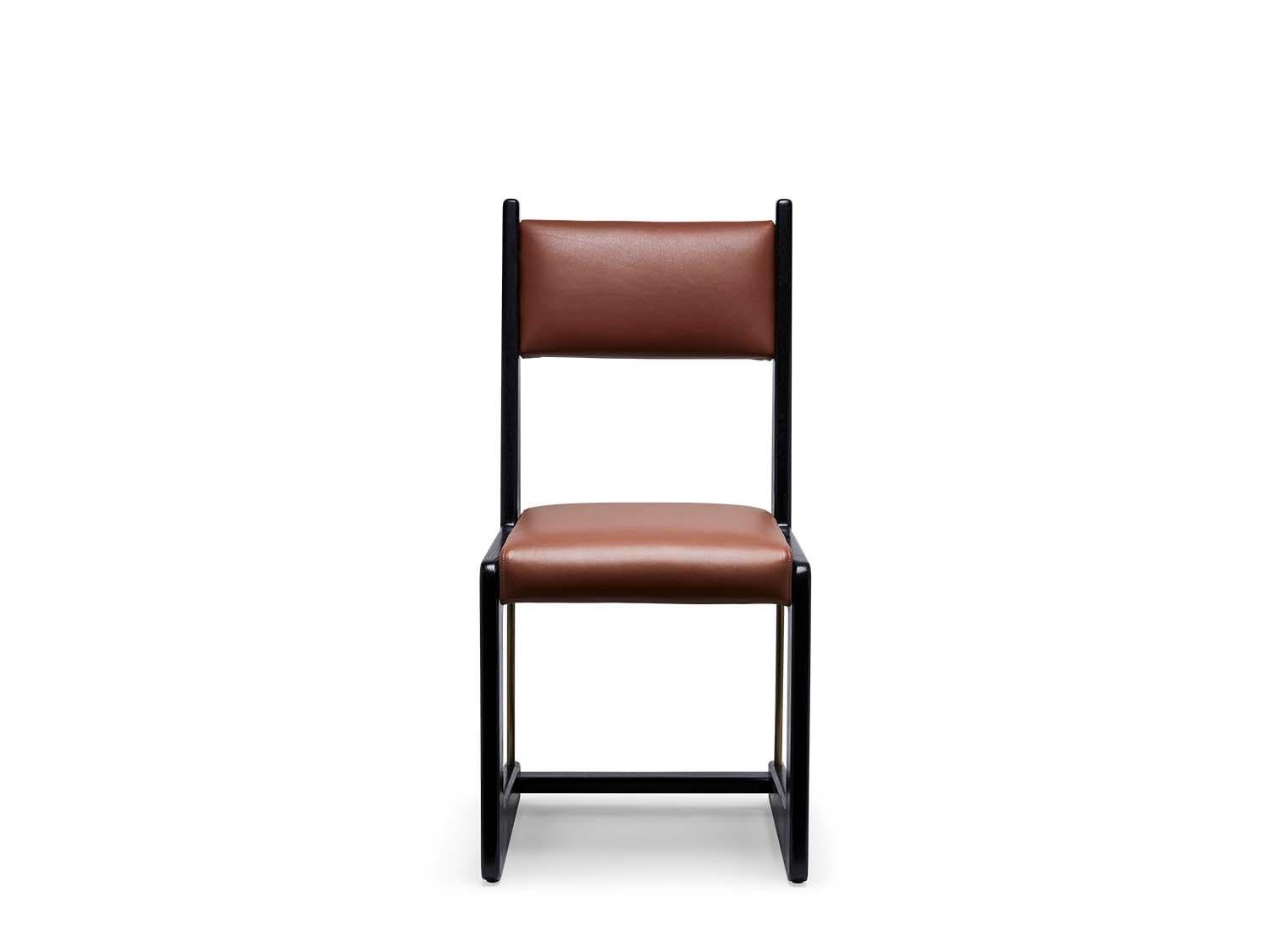 The Cruz dining chair is made from a solid American walnut or white oak frame that features a cantilevered shape and lacquered brass stretchers. The seat is upholstered.

The Lawson-Fenning Collection is designed and handmade in Los Angeles,