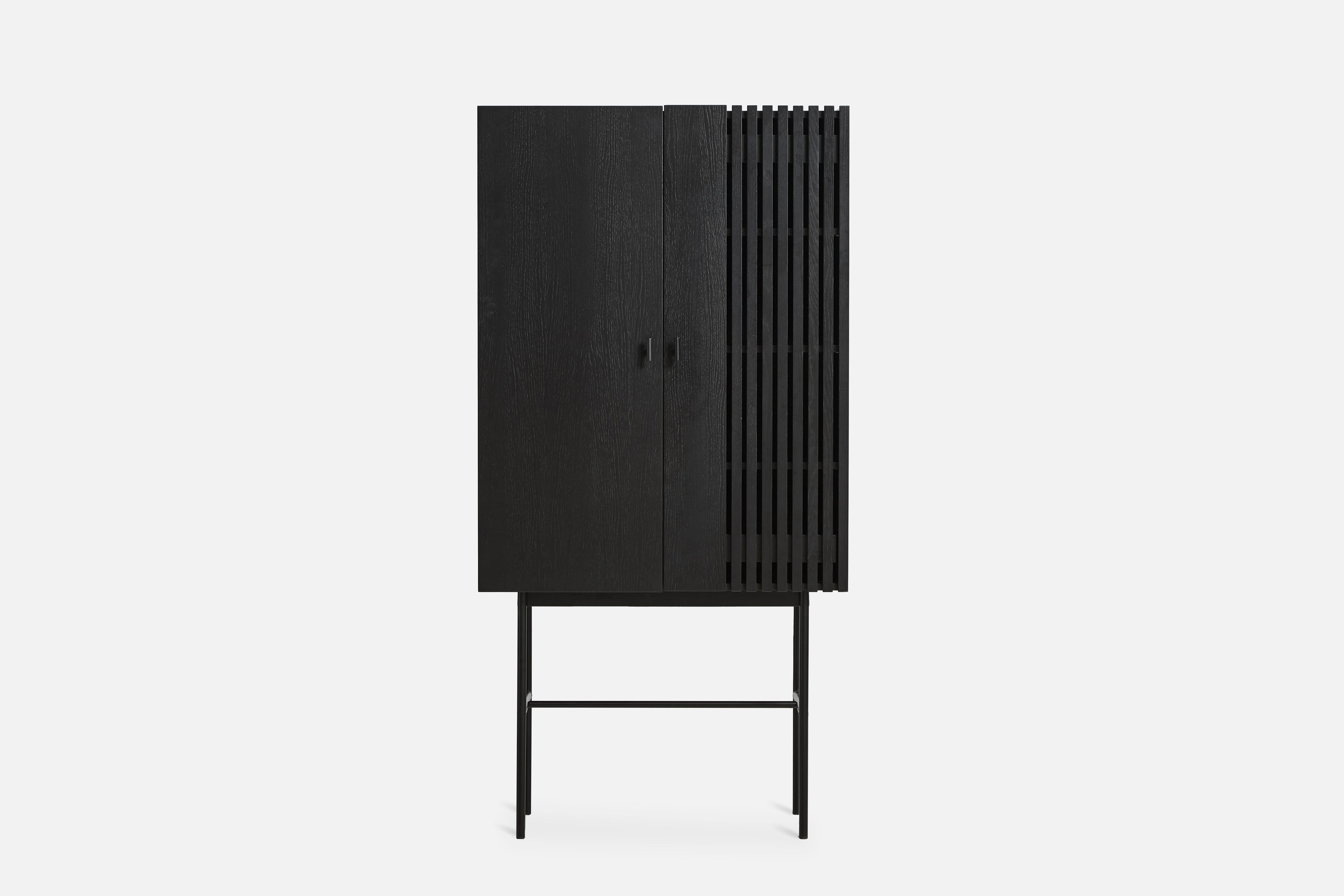 Black Oak Array highboard 80 by Says Who
Materials: Oak, Metal
Dimensions: D 44 x W 80 x H 160 cm
Also available in different colors and materials.

The founders, Mia and Torben Koed, decided to put their 30 years of experience into a new