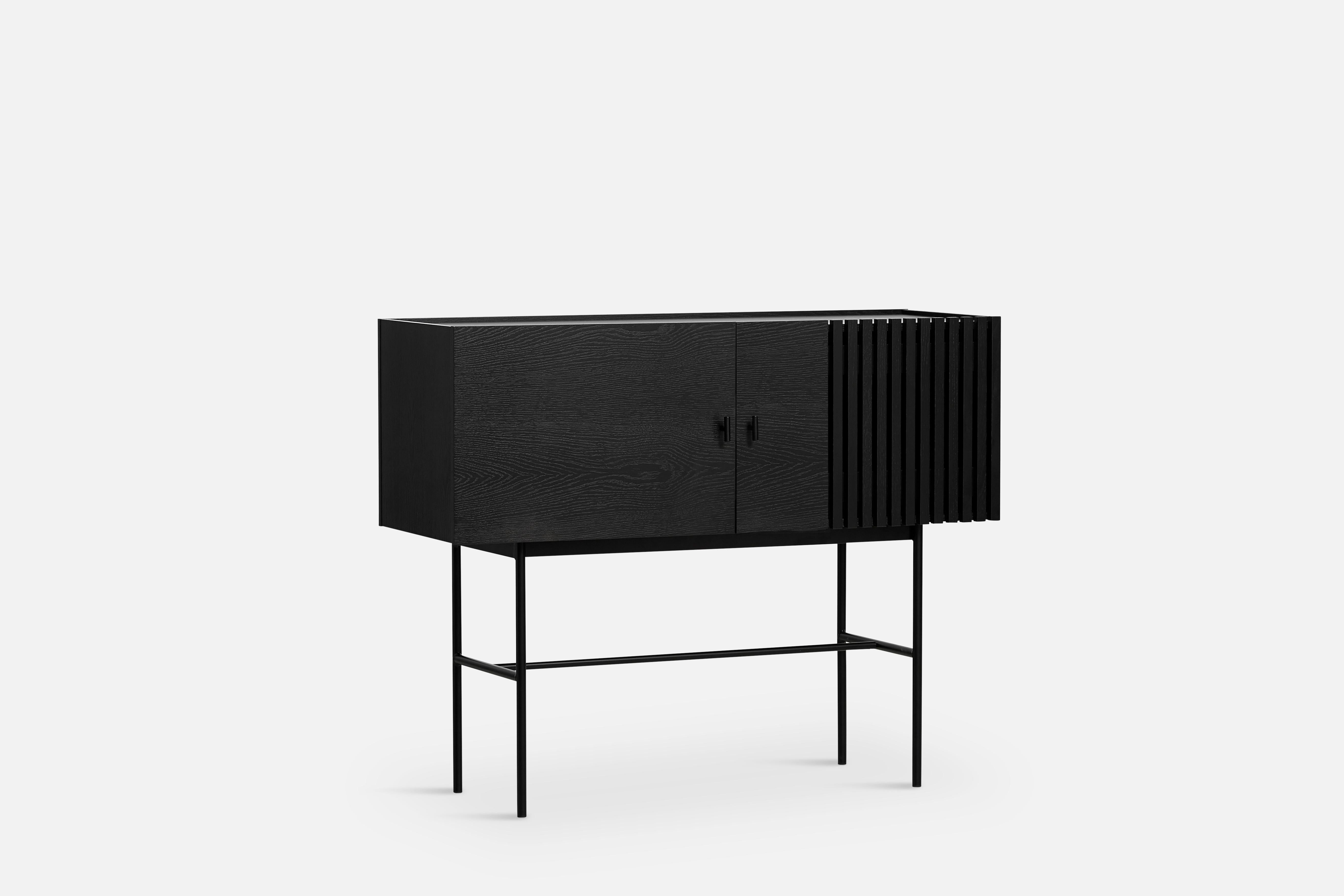 Black oak array sideboard 120 by Says Who.
Materials: oak, metal
Dimensions: D 44 x W 120 x H 97 cm
Also available in different colours and materials.

The founders, Mia and Torben Koed, decided to put their 30 years of experience into a new
