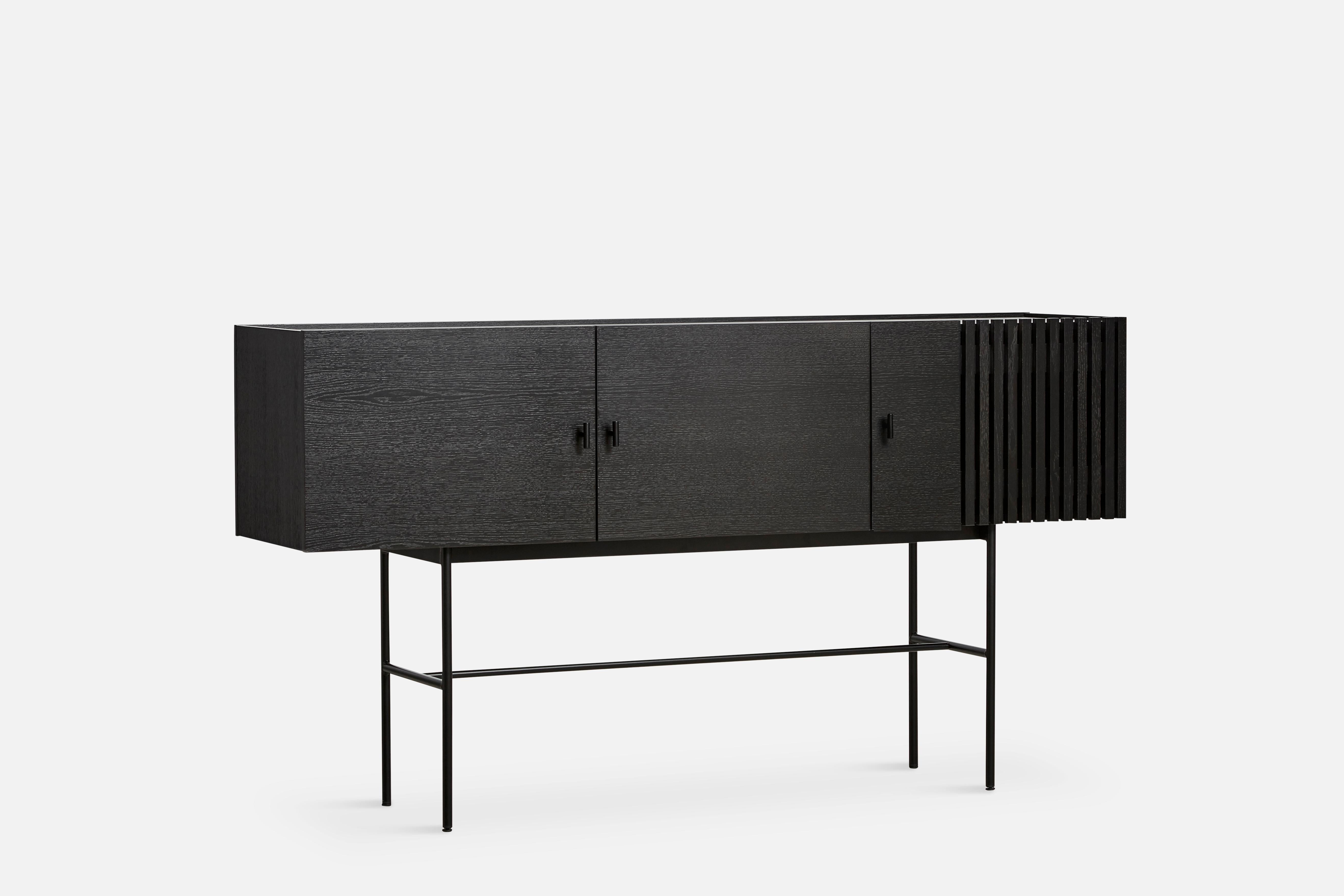 Black oak array sideboard 180 by Says Who.
Materials: oak, metal.
Dimensions: D 44 x W 180 x H 97 cm
Also available in different colours and materials.

The founders, Mia and Torben Koed, decided to put their 30 years of experience into a new