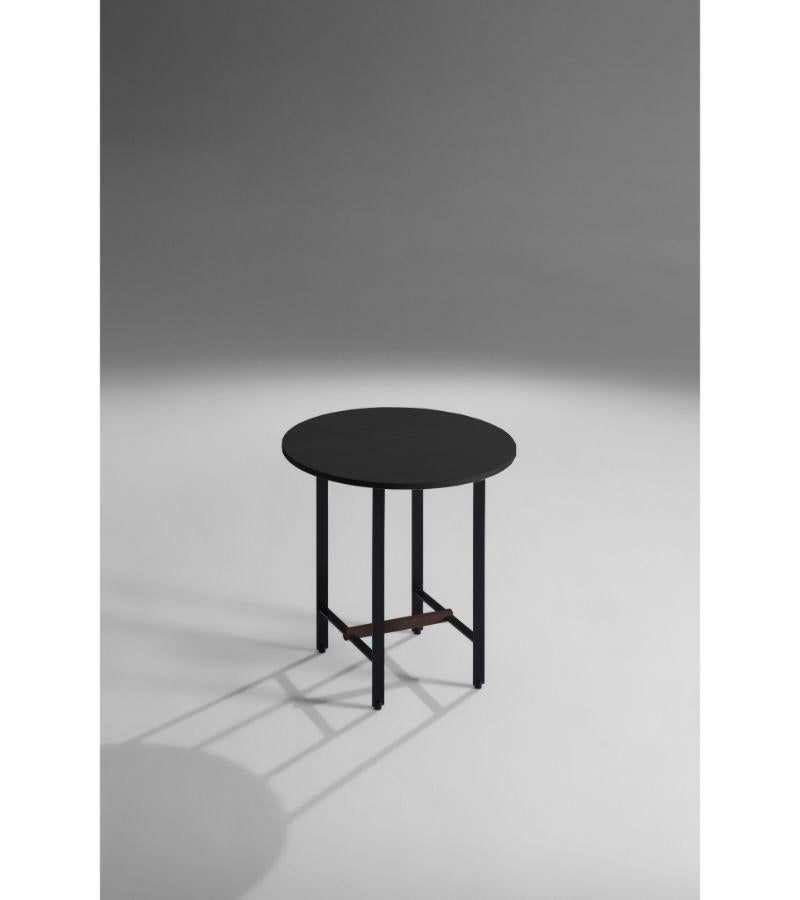 Black Oak Round Sisters side table by Patricia Urquiola
Materials: Bronze lacquered structure with the solid walnut cross member. Black varnished oak veneer or walnut.
Technique: Lacquered Metal. Varnished Wood. 
Dimensions: D 48 x H 50 cm
Available