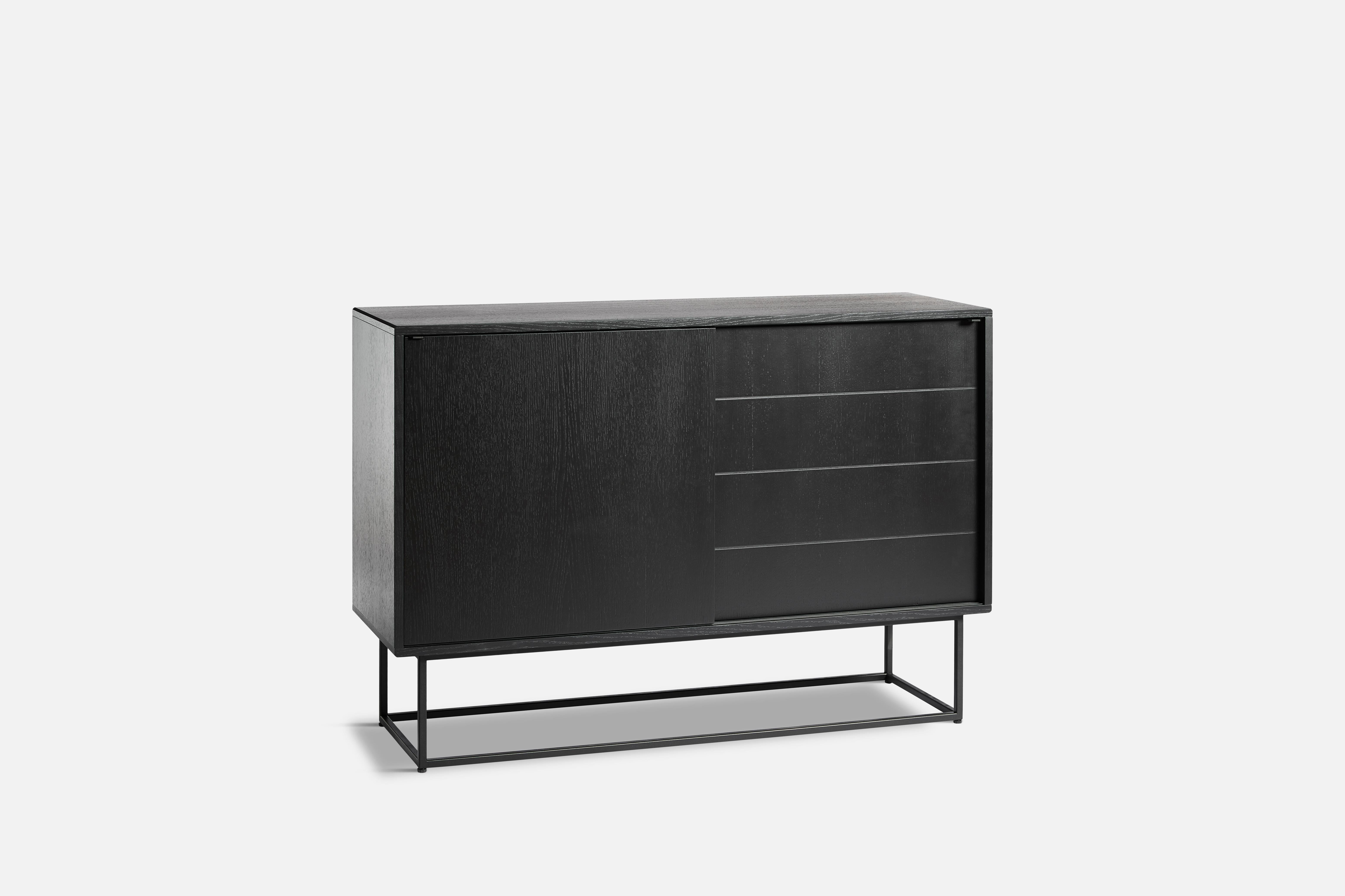 Black Oak Virka High sideboard by Ropke Design and Moaak.
Materials: Oak, Metal.
Dimensions: D 40 x W 120 x H 82 cm.
Also available in different colours and materials. 

The founders, Mia and Torben Koed, decided to put their 30 years of