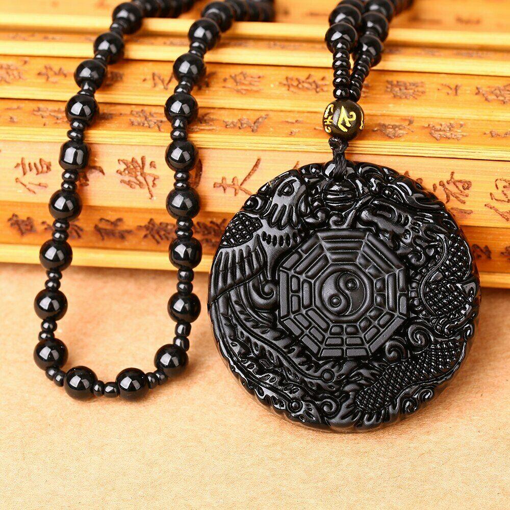 Black Obsidian  Chinese Dragon Necklace . This is hand carved too .  If you are wanting anything specific or like this in gold or something get in contact. Black obsidian is a beautiful natural stone formed by cooled volcanic lava. It's smooth and