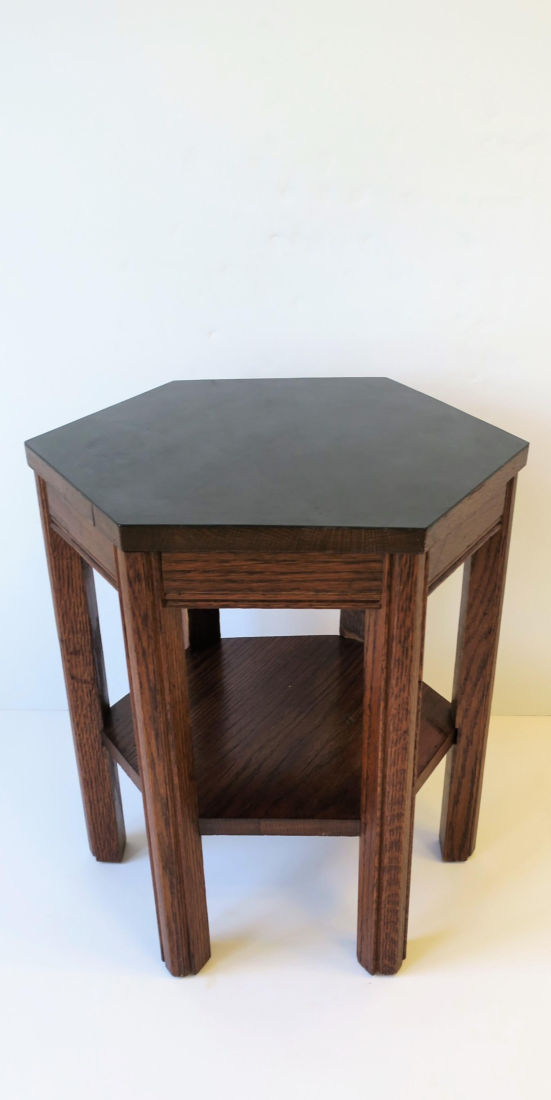 A small midcentury octagonal shaped side or drinks table with black veneer top and lower shelf. 

Table measures: 17 in. W x 15 in. D x 18 in. H.