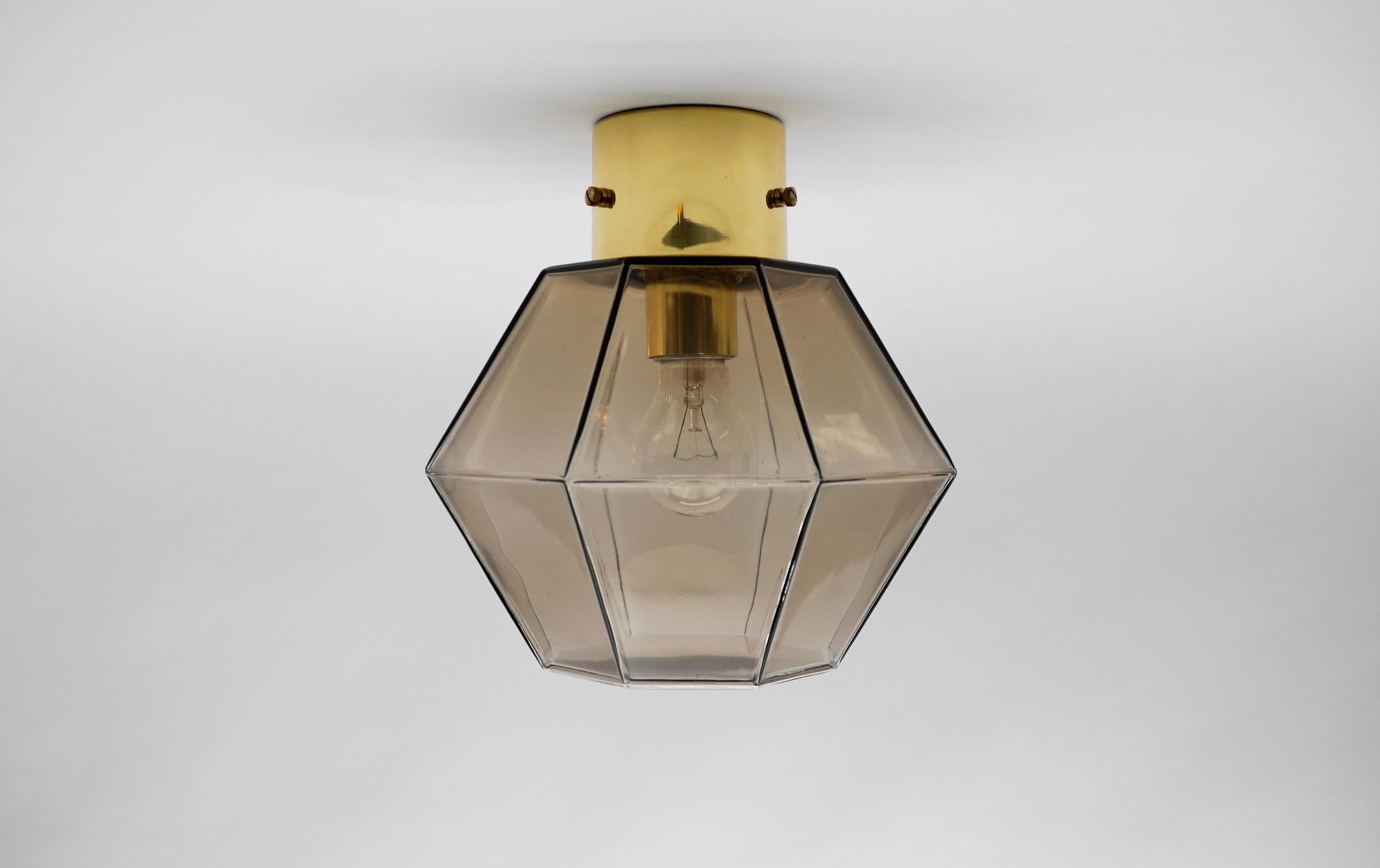 Black Octagonal Smoked Glass Flush Mount by Limburg, Germany 1960s

Dimensions
Height: 10.23 in. (26 cm)
Diameter: 10.23 in. (26 cm)

The fixture need 1 x E27 standard bulb with 60W max.

Light bulbs are not included.
It is possible to install this