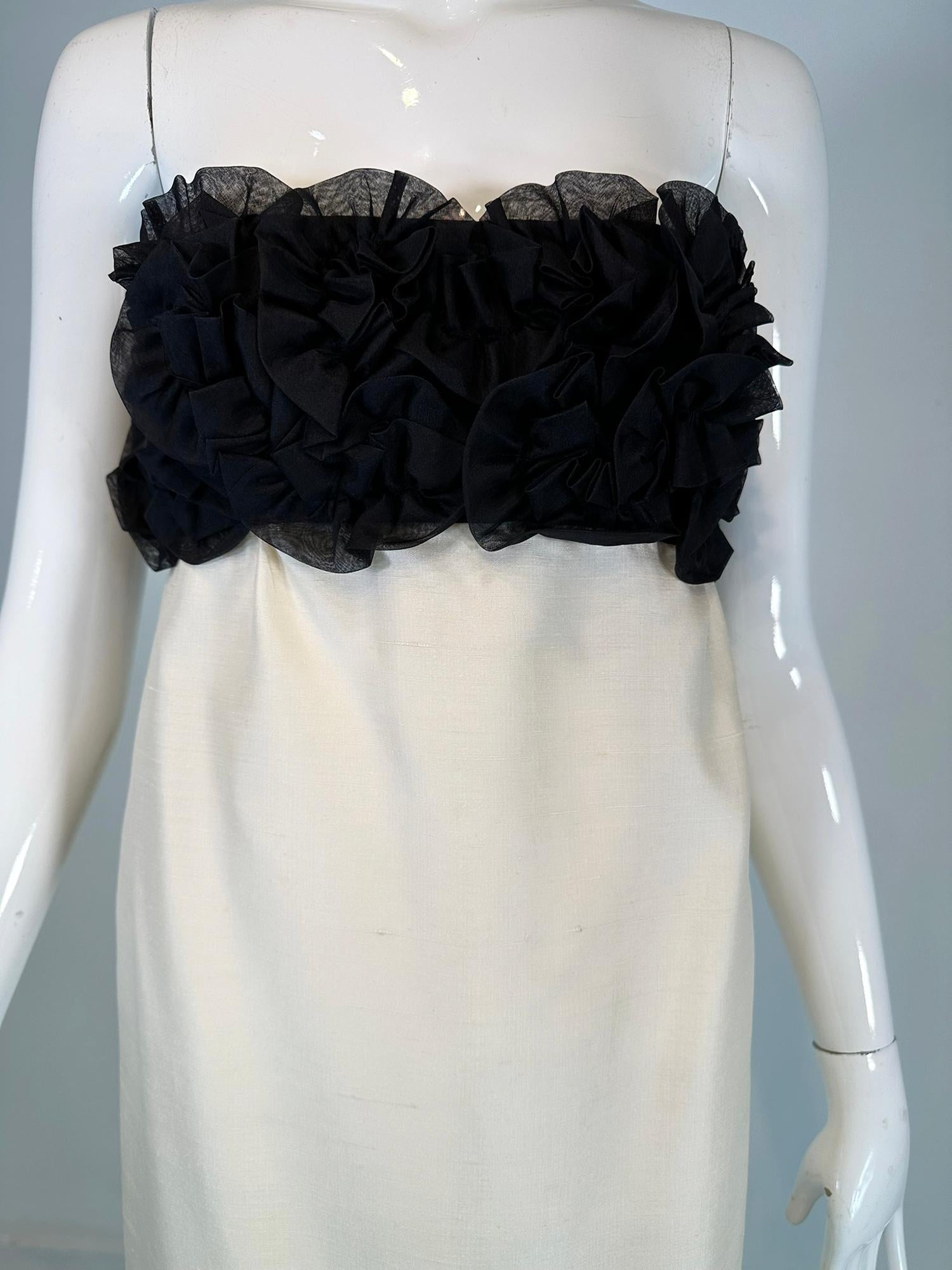 Black & Off White slub silk & silk organza strapless cocktail dress from the 1960s by S.Howard Hirsh California.
100% slub silk strapless cocktail dress from the 1960s that is still relevant today. The bodice is black silk organza with organza 