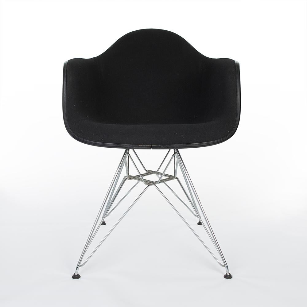 This is a used, newer version of the original Vitra Eames upholstered DAR armchair. This black upholstered DAR is a rather newer version, therefore it is in a very good condition. The fabric may require a little maintenance, however overall it is in