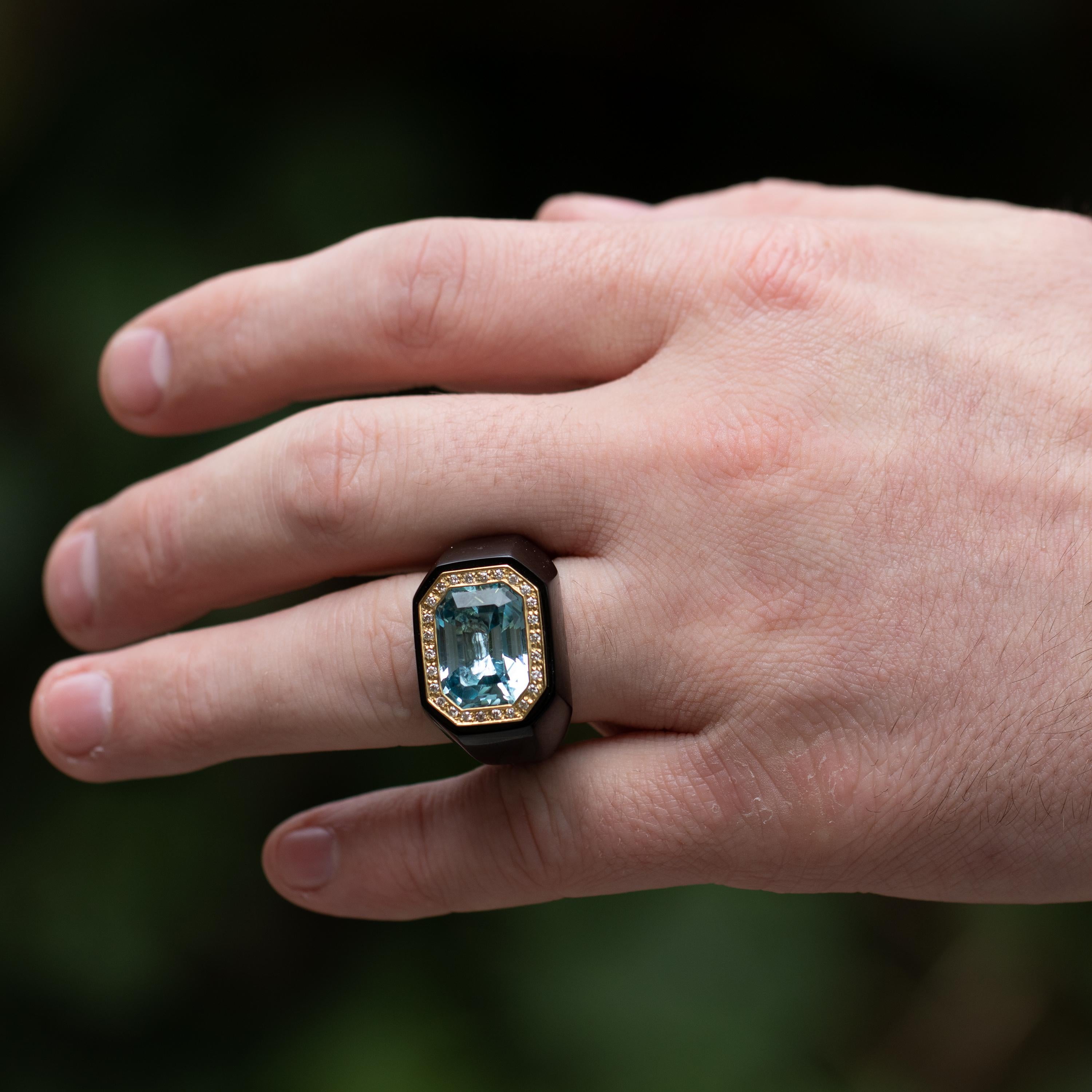 This Black Onyx Ring with a 10 Carat Aquamarine radiates True Luxury. Standing almost Half an Inch Tall, it's big, set at size 8.5, but it's also stunning, and very Elegant. 
Aquamarine = 10 carats
Diamonds = .66 carats
18K Yellow Gold
Gemstone: