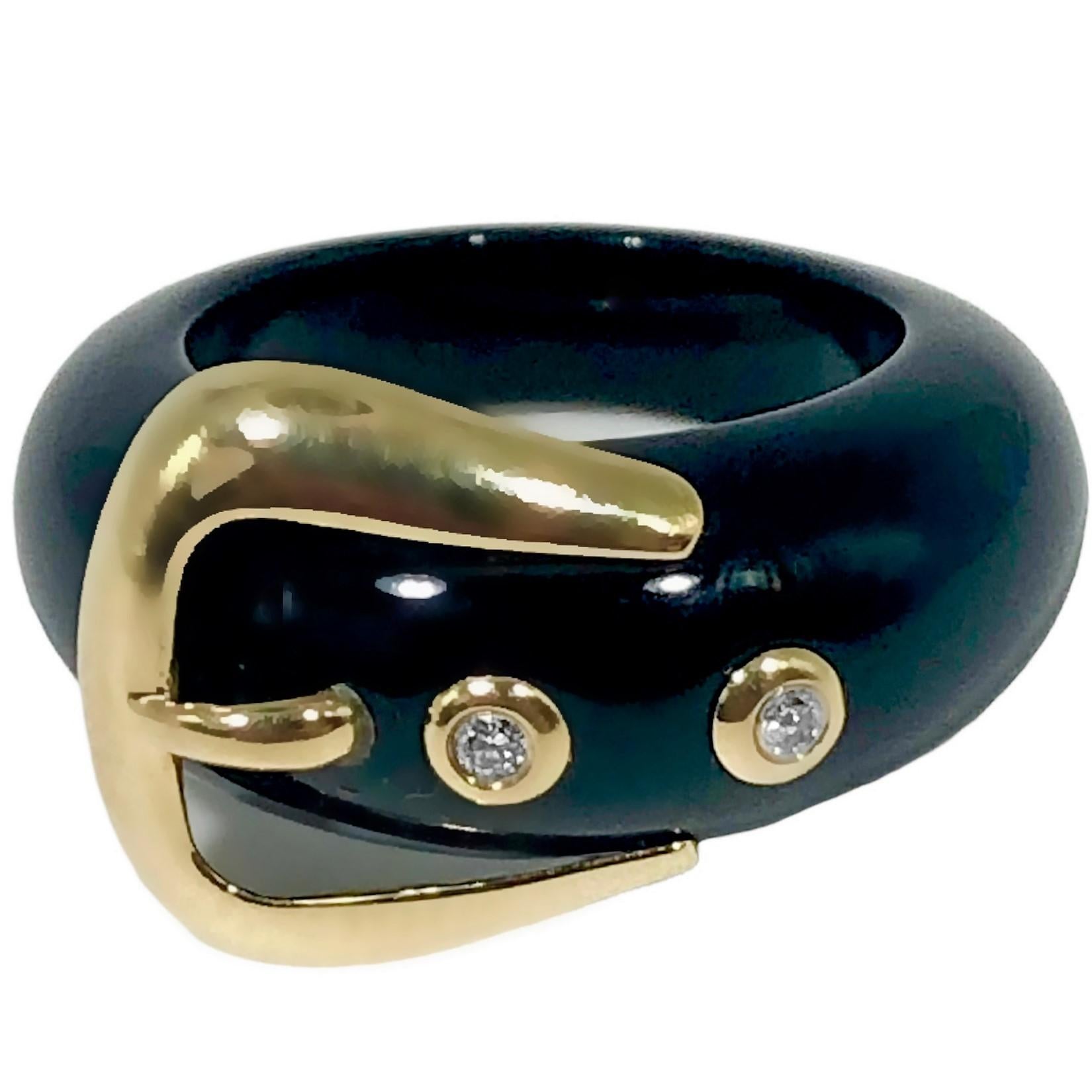 This stylish buckle ring consists of a band of black onyx, graduating from 5/16 inches at the front down to 1/8 inches at the rear.  Affixed to this band are a 14k yellow gold buckle and two individual, gold bezel set brilliant cut diamonds, with a