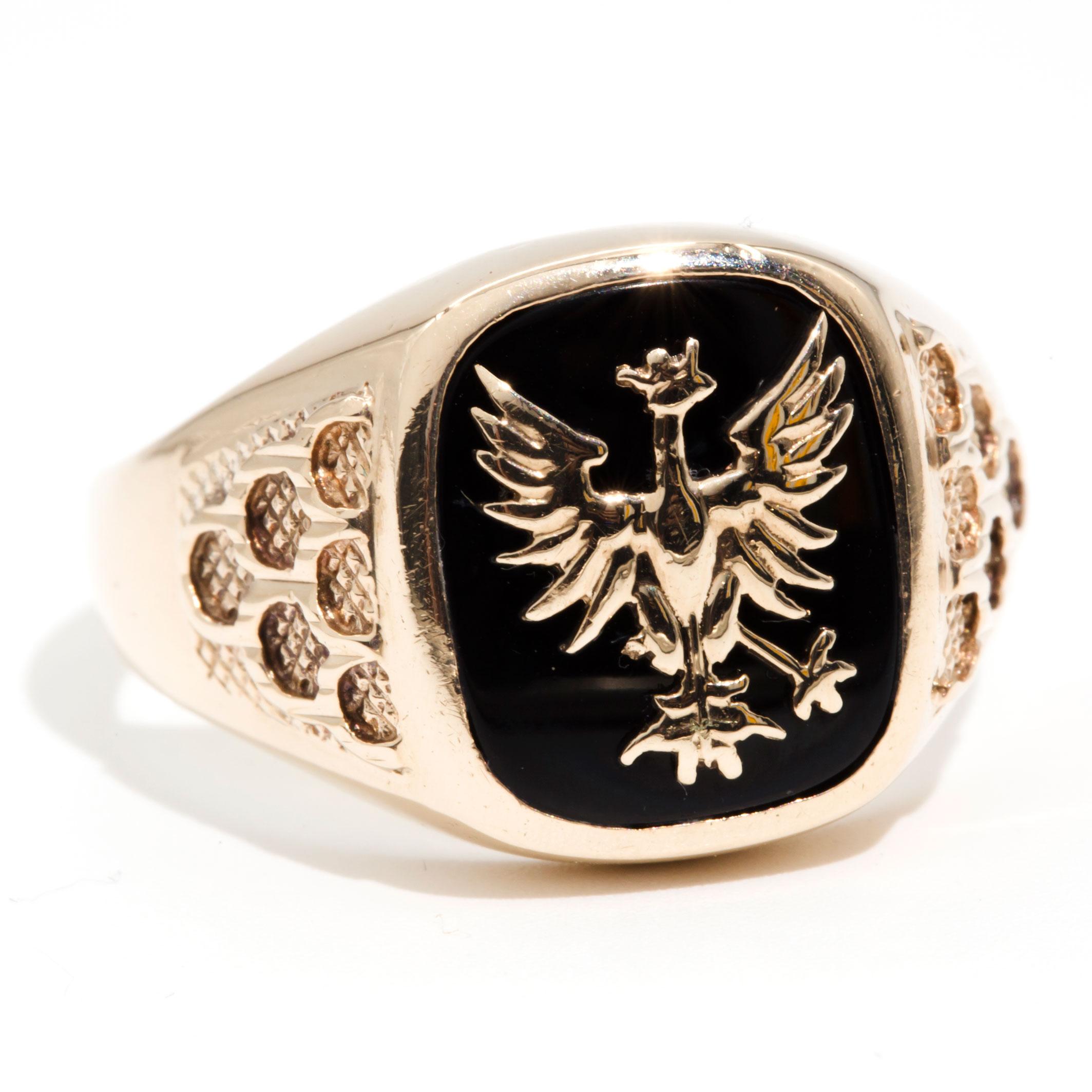 Forged in 9 carat yellow gold, this handsome vintage mens signet ring featuring a cushion shape flat dome top with a black onyx and a unique gold Pheonix feature on top. We have named this dapper piece The Andy Ring. The Andy Ring has a high