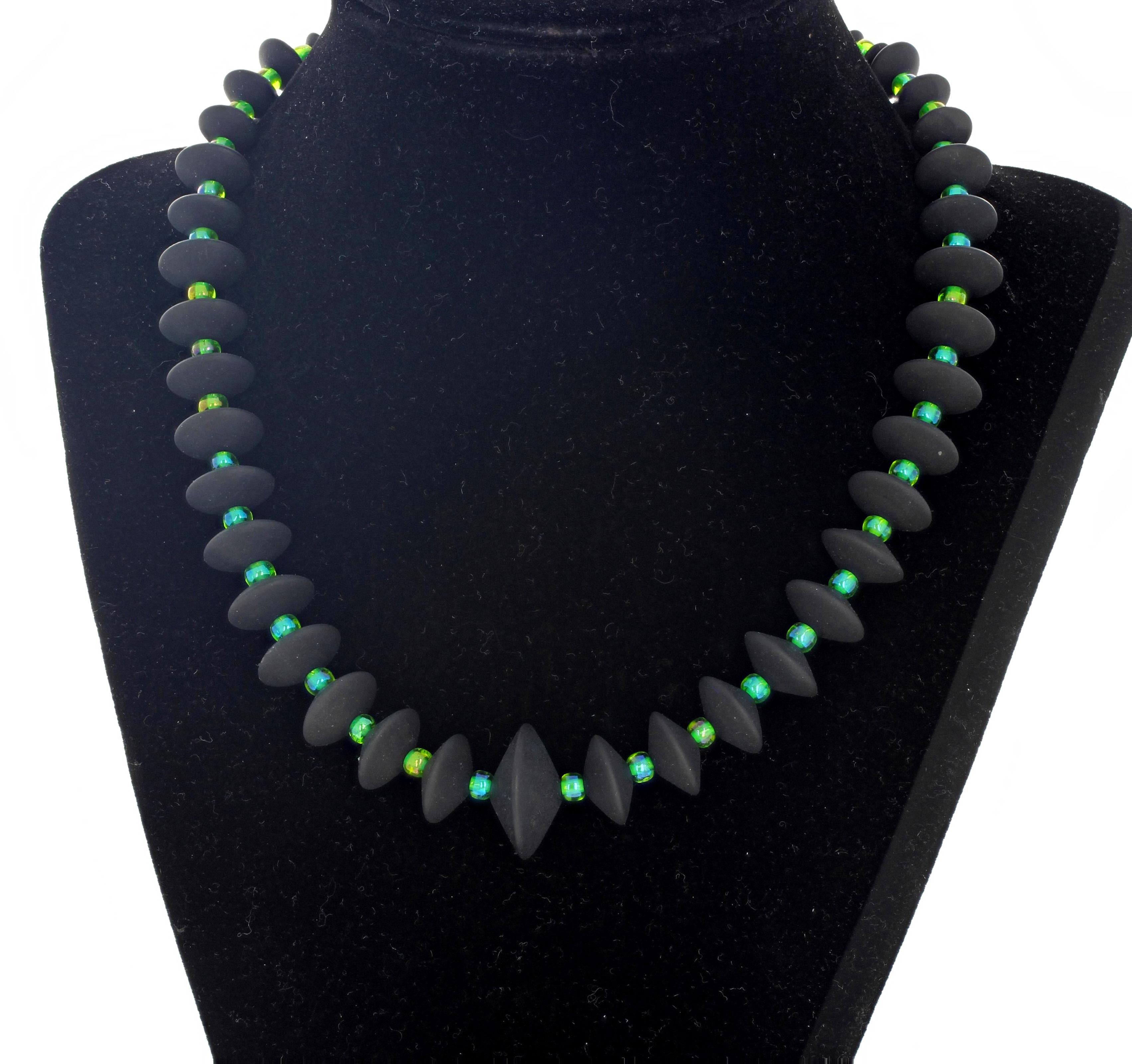 Lovely rondels ( largest 20 mm) of real Black Onyx enhanced with glittering greenish-bluish Czech crystals form this handmade necklace 17.25 inches long with a gold tone clasp.  This is superbly elegant on a black blouse or sweater. 