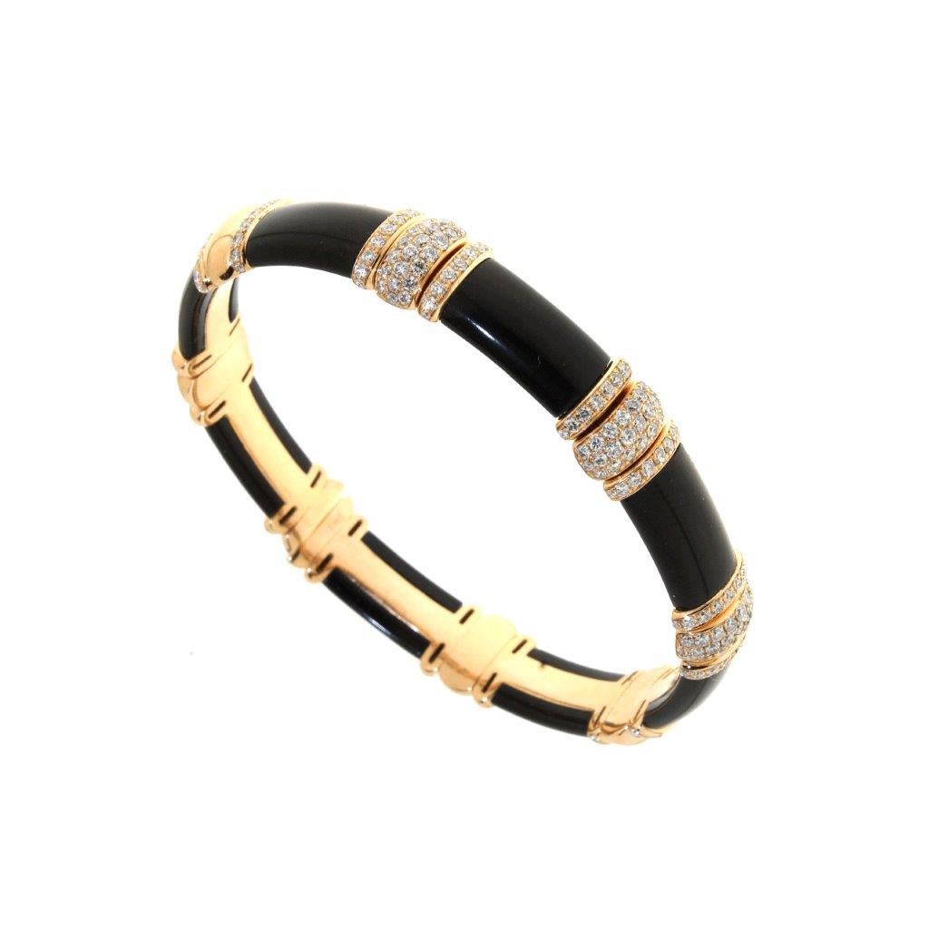 This contemporary design bangle bracelet is set with black onyx gemstones and pave set diamond stations. Handcrafted in Italy 18k rose gold. The diamonds weigh 1.52cts.