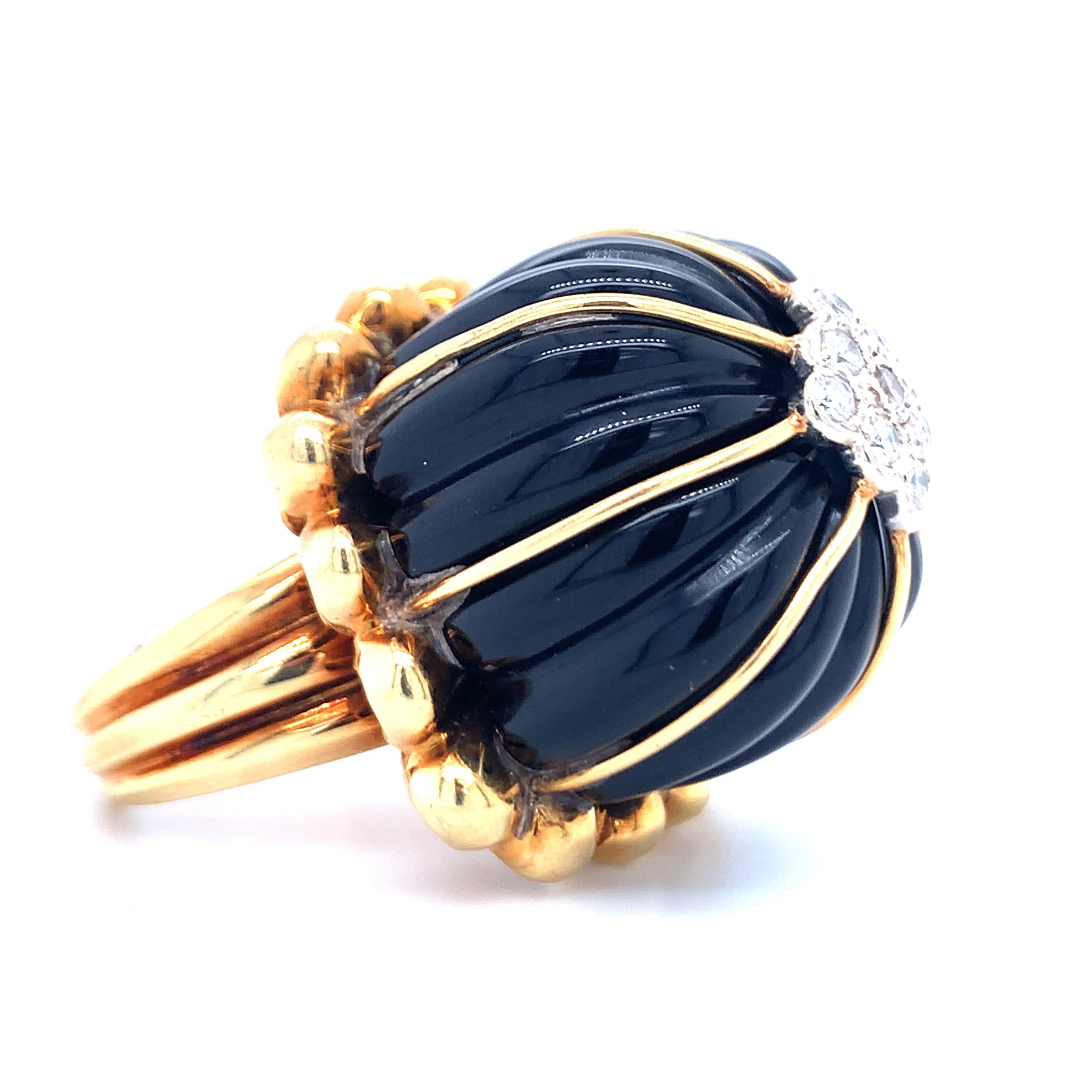 Black onyx and diamond 18K yellow gold ring featuring a dome shaped, high dimension onyx portion featuring a diamond encrusted top featuring nine round brilliant cut diamonds totaling 0.30 ct. with H color and VS-2 clarity. Completed with a puffed,