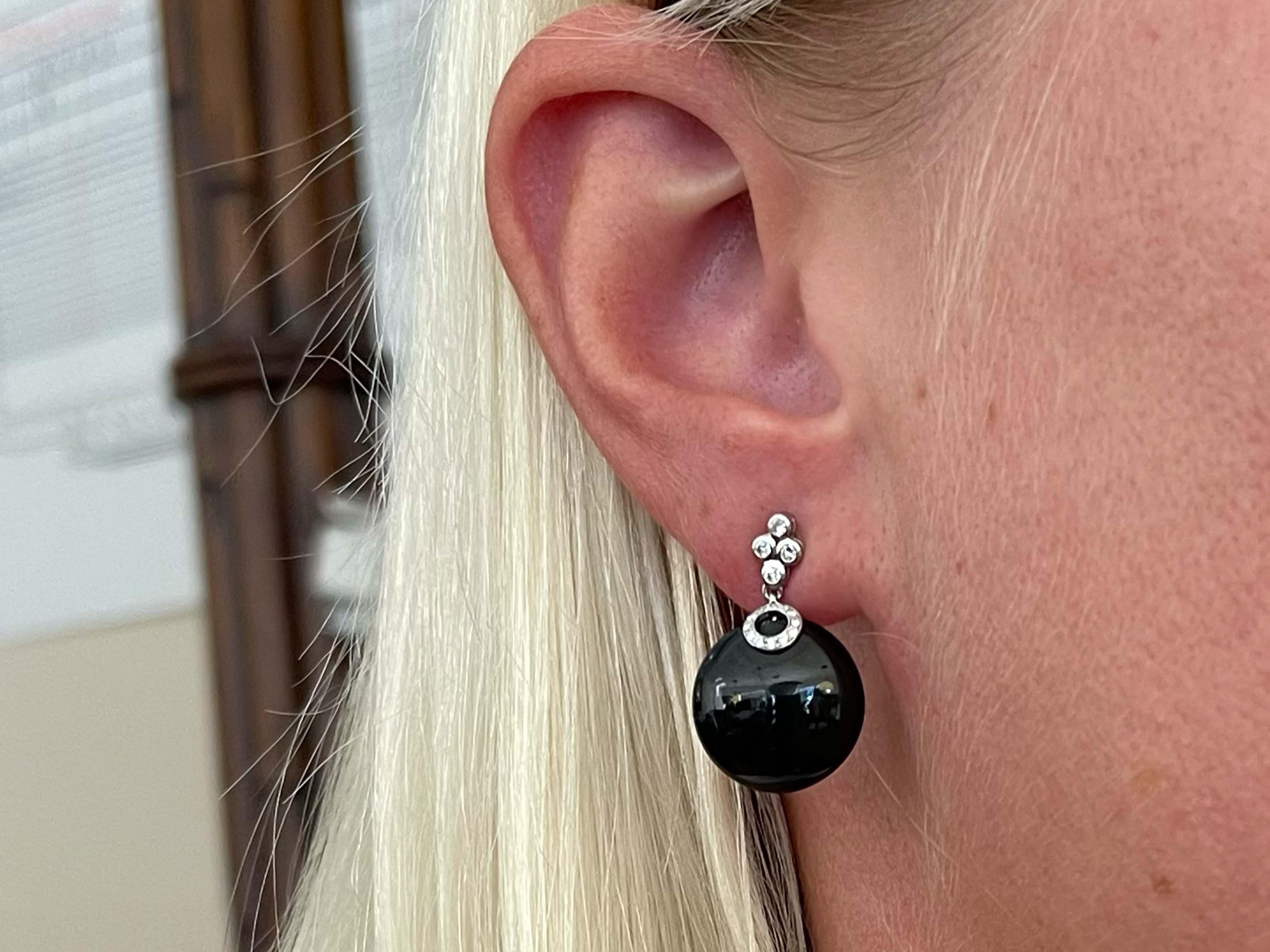 Item Specifications:

Style: Diamond & Black Onyx Earrings

Metal: 18K White Gold 

Diamond Color: G-H

Diamond Clarity: VS

Diamond Weight: 0.14 carats

Weight: 7.0 Grams
​
​Onyx Diameter: 15.47 mm

Earring Length: 24 mm 

Condition: Vintage,