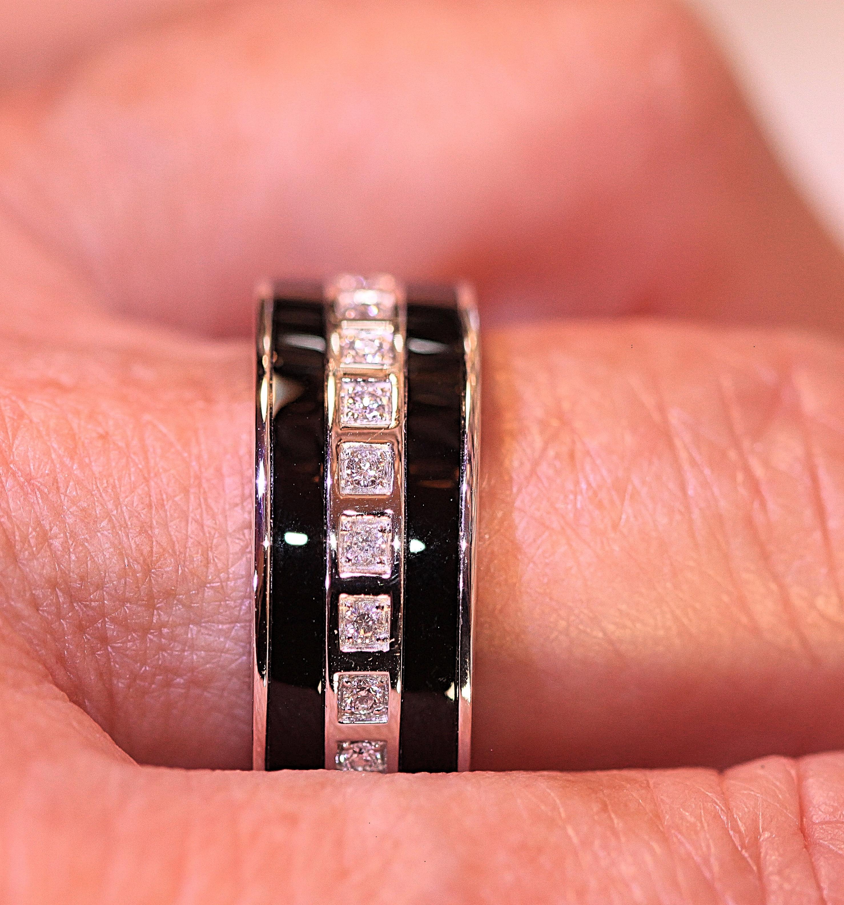 A stunning gentleman's ring.  The ring has eleven round brilliant cut diamonds that are set in square heads. The diamonds weigh .20 carat and the diamonds have a row of onyx on each side.  The ring measures 9 mm at the top and it is a size 11 1/2.