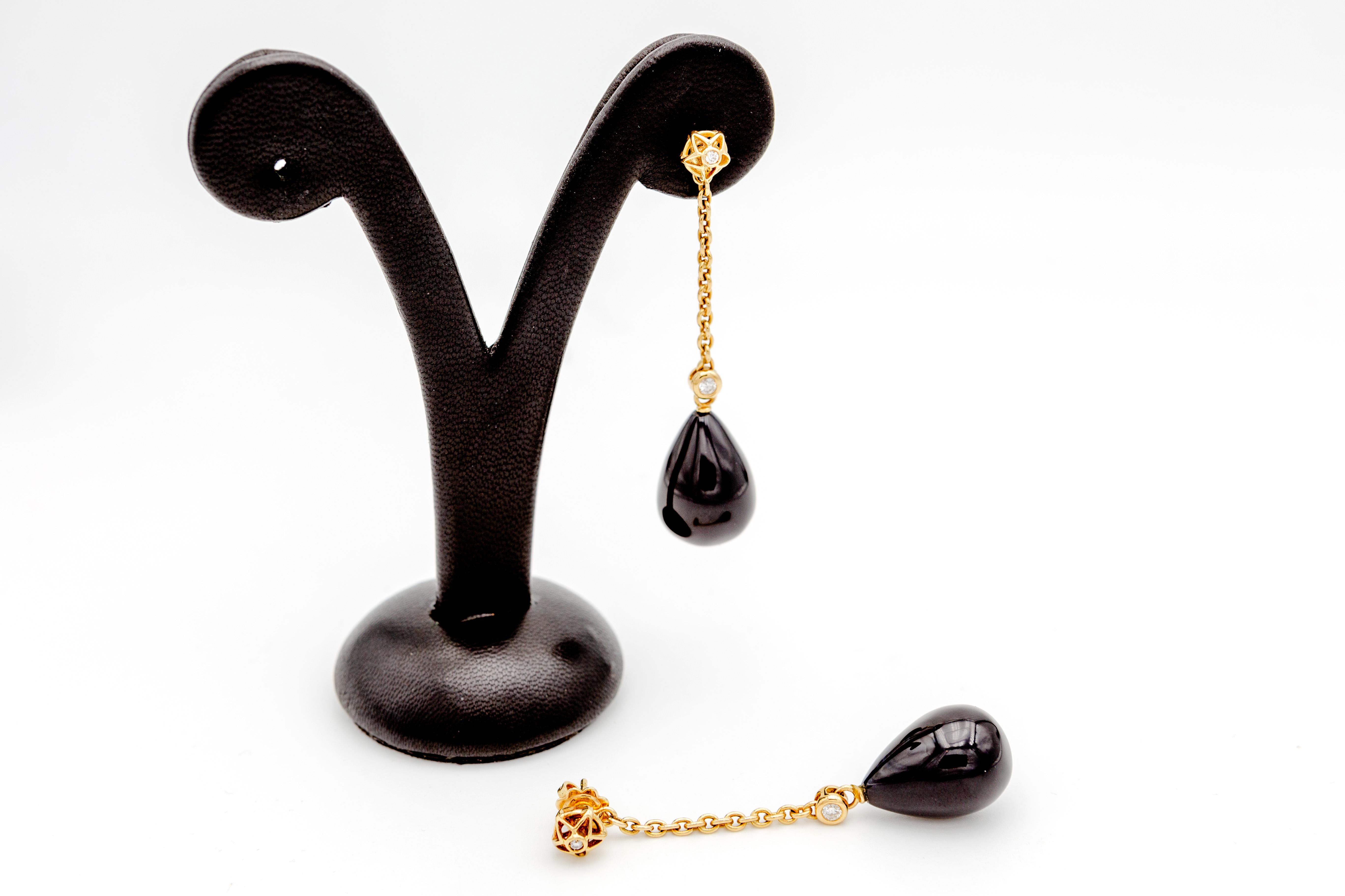 Pair of long swinging earrings handmade in 18kt yellow gold with two Black Onyx drops (15x20mm) and 0,20 Carats Diamonds.