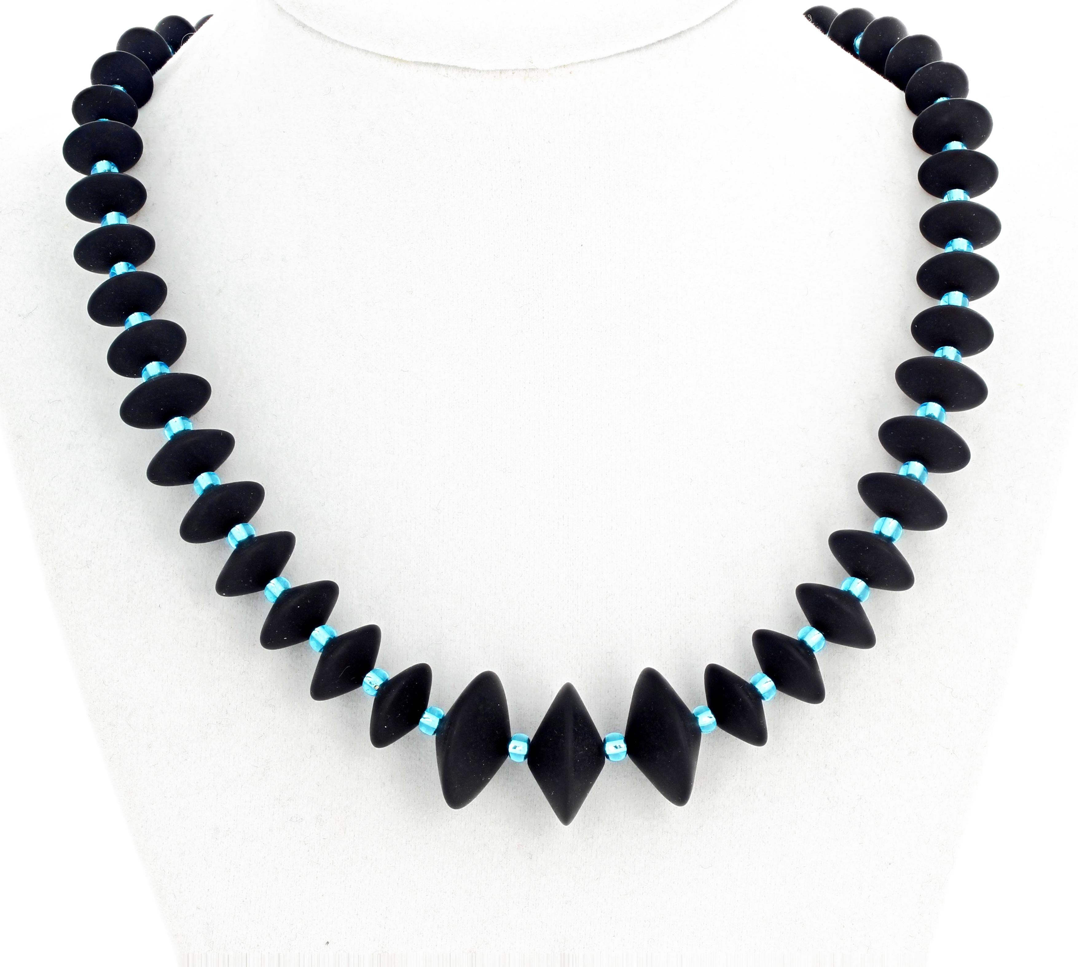 Unique Black Onyx rondels (largest 20 mm) enhanced with brilliant glittering blue Czech crystals set in an 18 inch long necklace with gold tone hook clasp.  