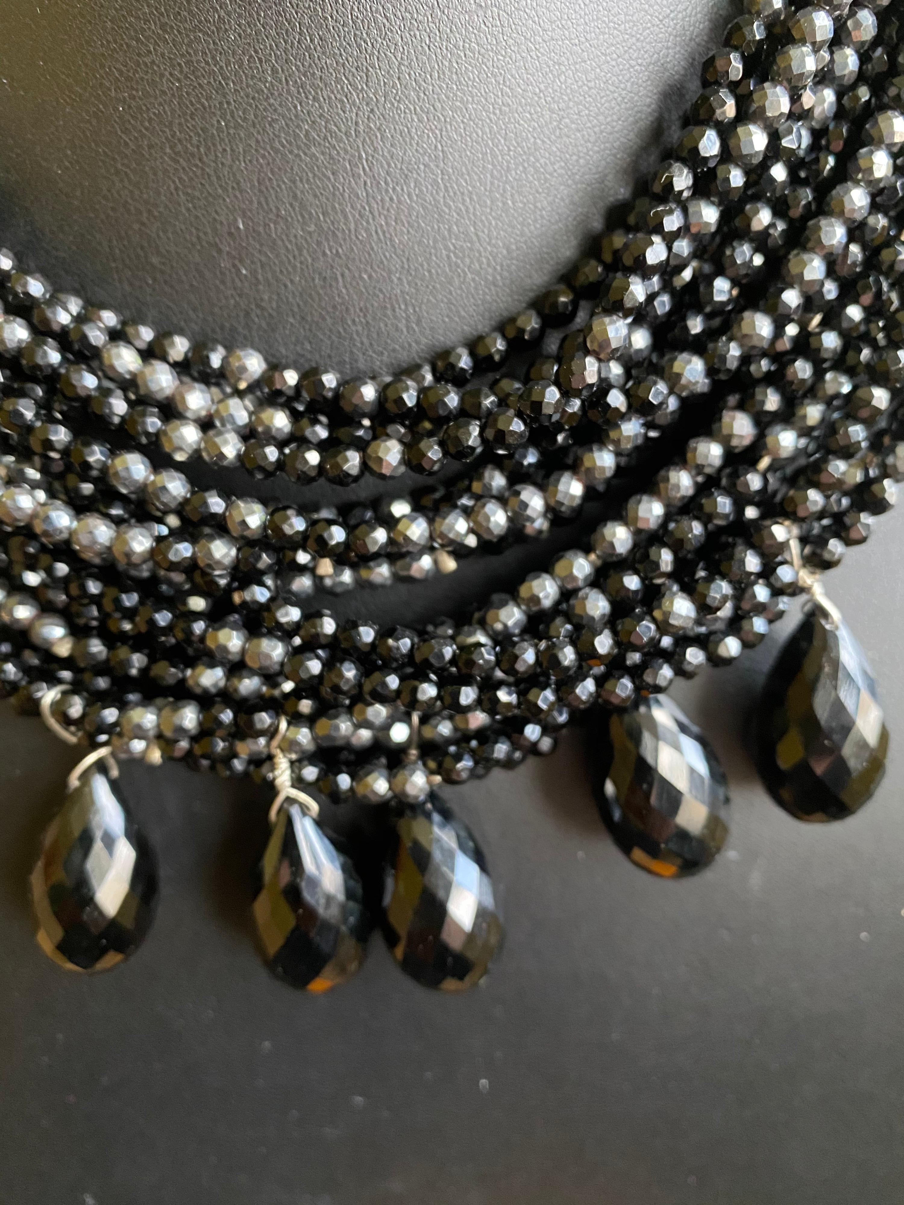 This is from the Jane Magon Collections Business Woman Collection with 22 twisted strands of gemstone beads, Hematite and Black Onyx Beads with Five Faceted Black Onyx Large Briolettes make the perfect accessory to any outfit. Fits as a chocker but