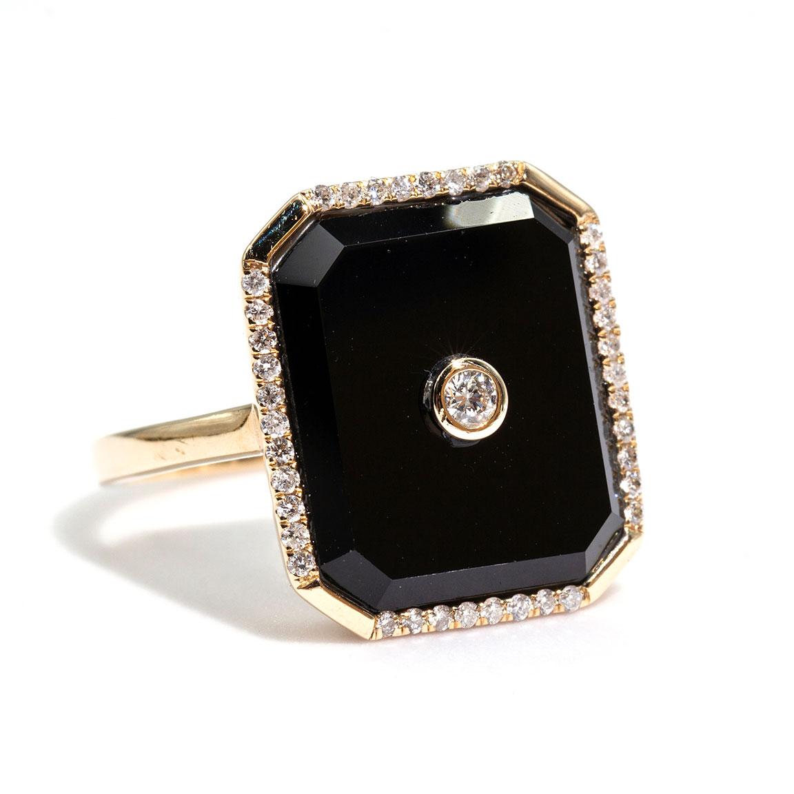 Carefully crafted in 9 carat yellow gold is this gorgeous Art Deco inspired Onyx and Diamond ring. The spectacular contrast between the polish of the Onyx and the sparkle of the diamonds is pure opulence.  We have named this unforgettable piece The