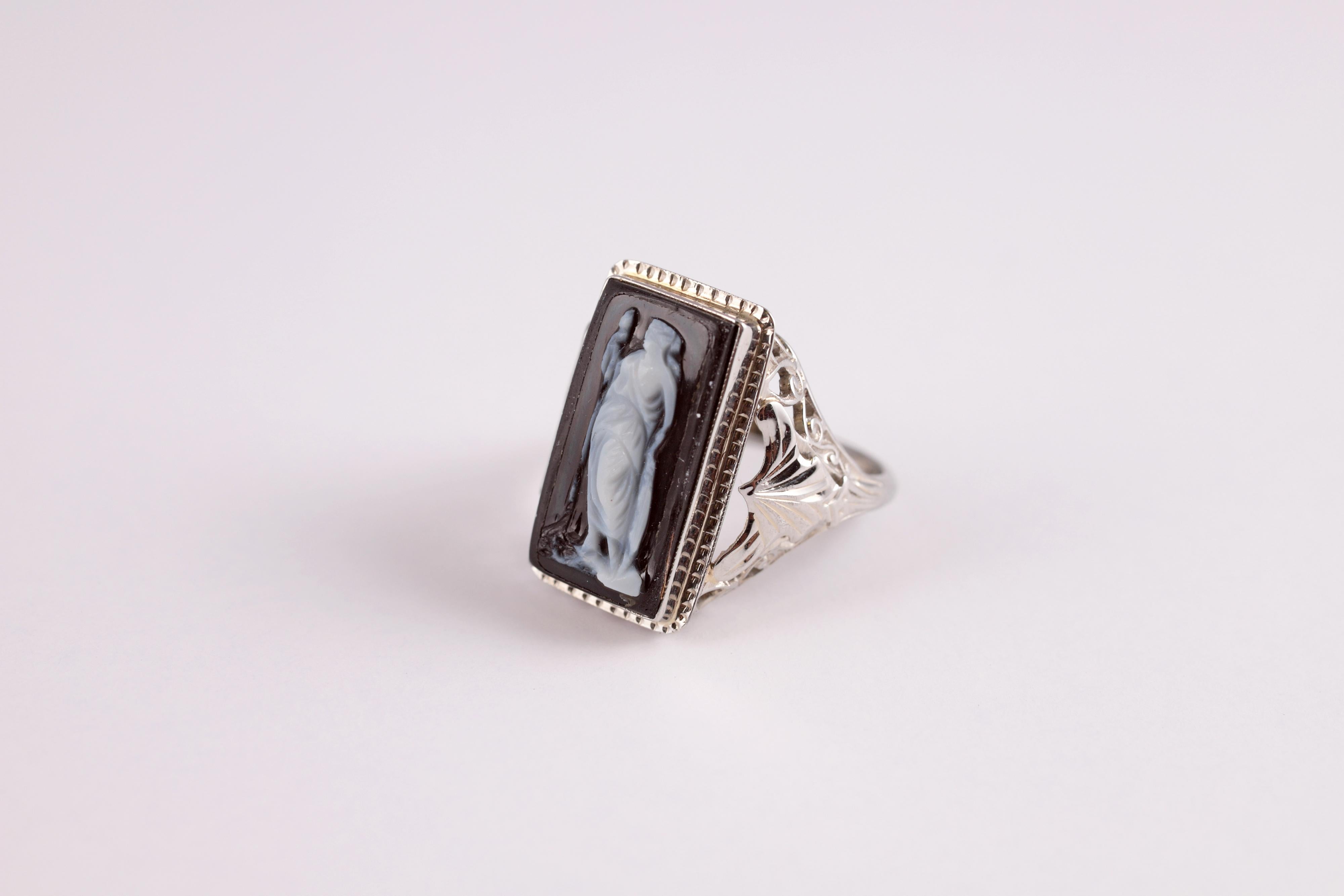 Black onyx cameo ring set in 10 karat white gold. Beautifully detailed setting is a size 5.