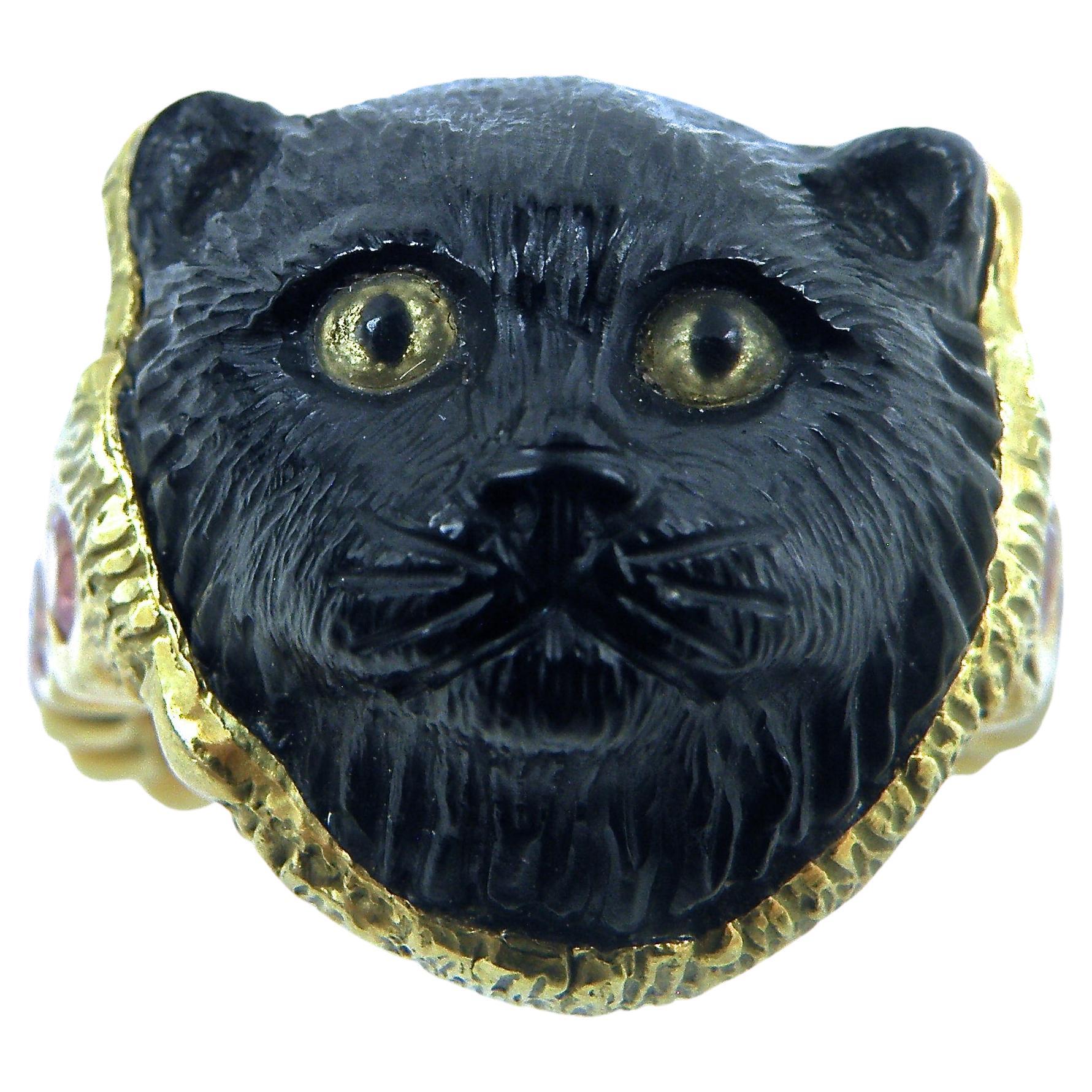 18K, beautifully hand carved Onyx Cat Head, Carved by Master Carver Idar Oberstein. Citrine eyes, .80 carats of Pink Sapphires in eternity band.