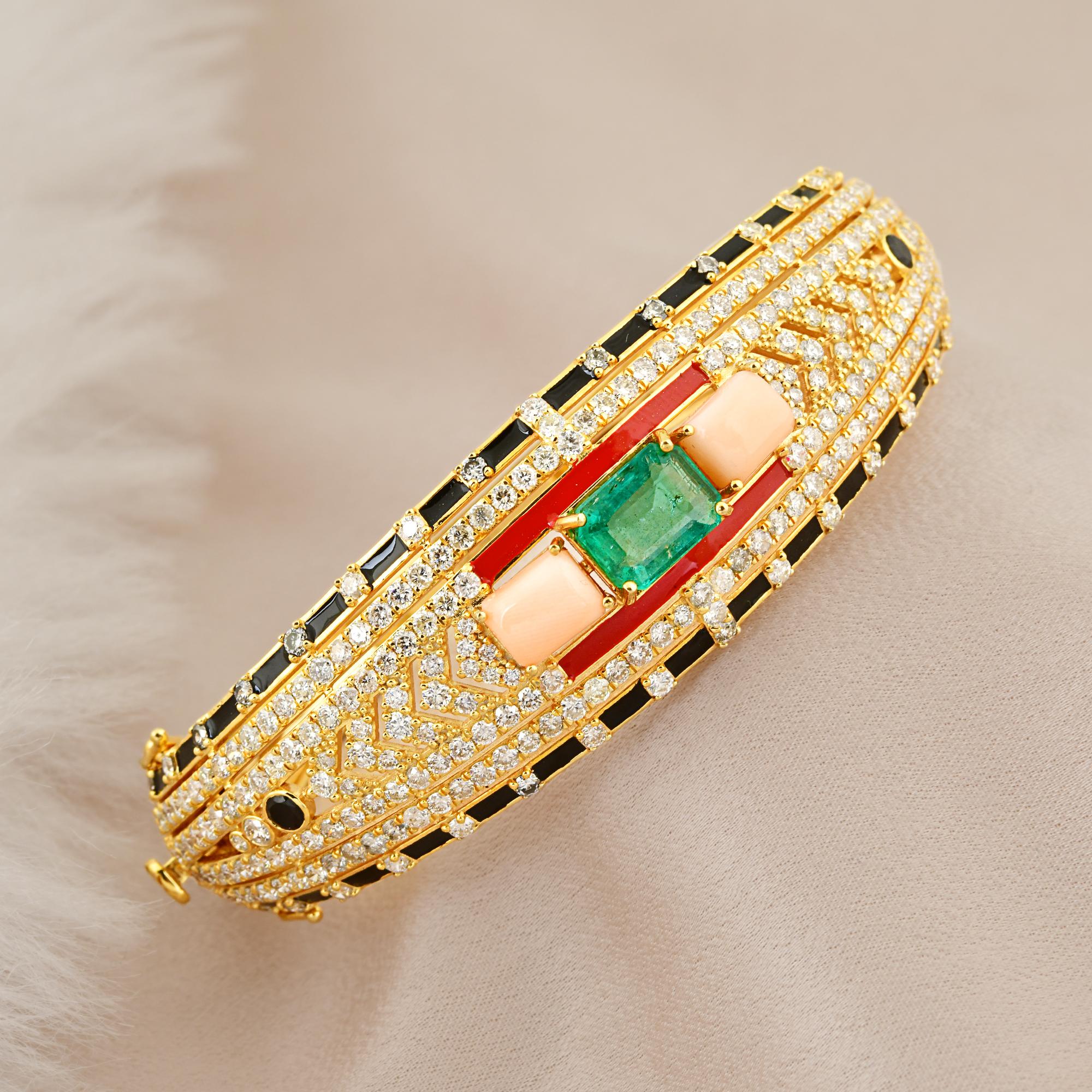 Introducing the exquisite Black Onyx Coral Emerald Bangle Bracelet in 18k Yellow Gold with Diamond accents and Enamel detailing. This bracelet is a true work of art, combining bold gemstones, luxurious gold, and intricate enamel work to create a