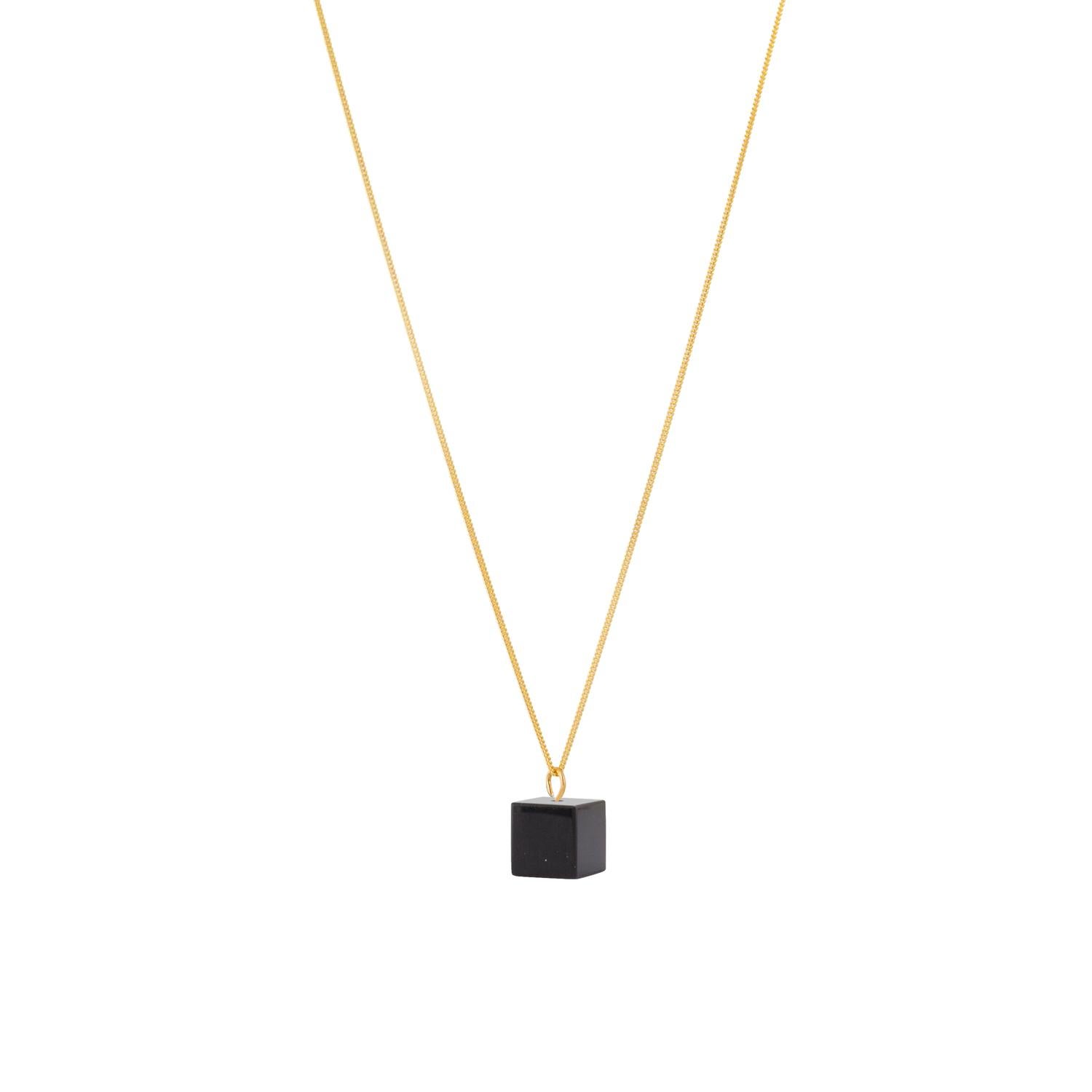 Simple and colourful, this Black Onyx necklace is made in our Northern Irish workshop. Carved by hand the 10 mm cube shape is set to fit onto a 45cm long 9 Carat Gold necklace.

Sourced in India, Black onyx is a deep black monochrome stone which is