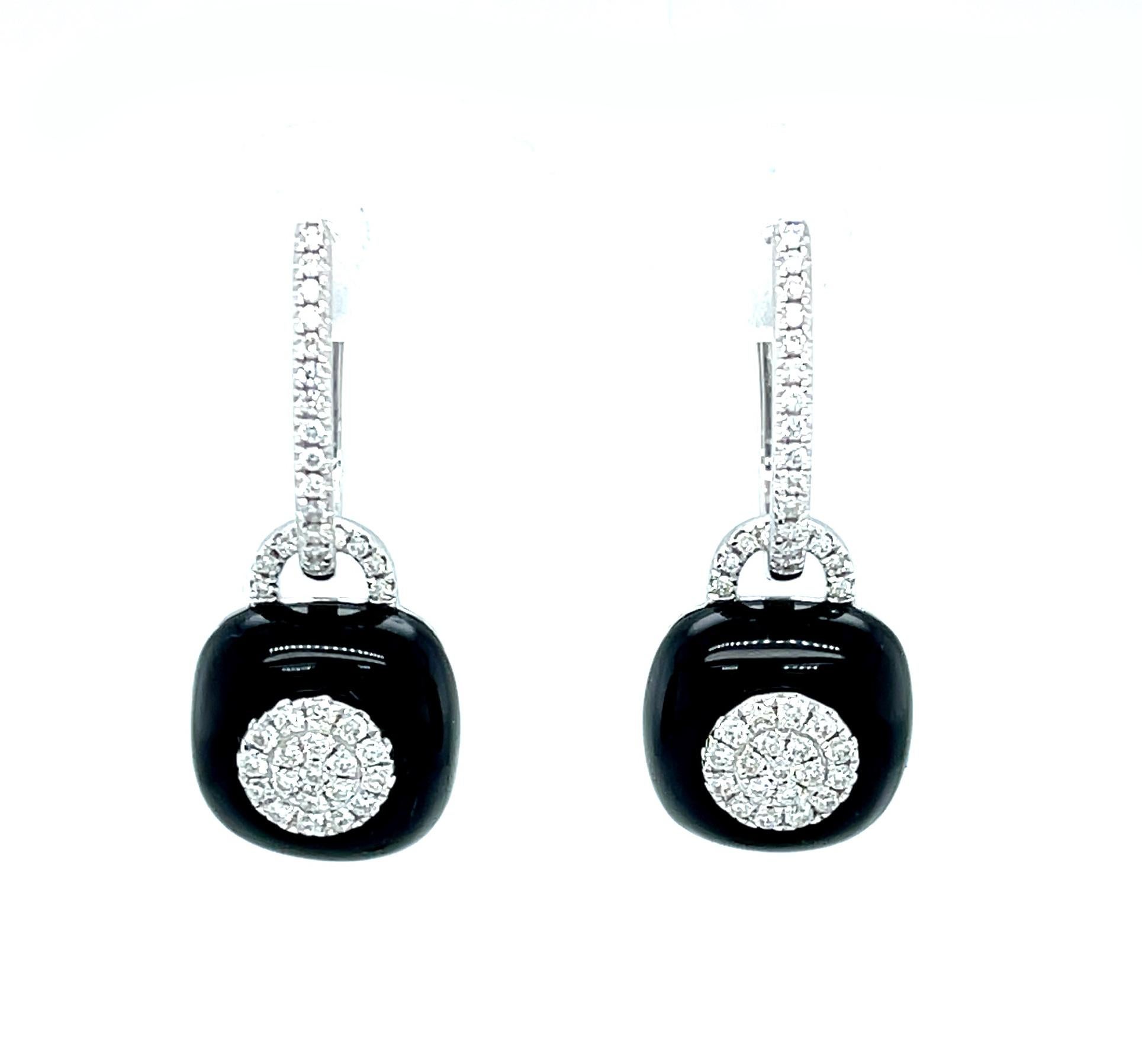 These beautiful 18k white gold earrings will dress up any daytime or evening outfit! Rich black onyx, inlaid with an intricate pattern of pave-set diamonds, dangle below elegant diamond hoops! You'll love this design with its bold color contrast,