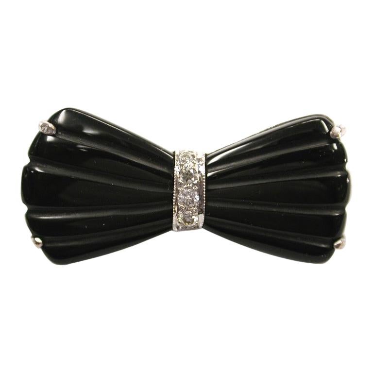 Black Onyx Diamond Bow Brooch Mounted in 9 Carat White Gold Dated circa 1930s For Sale