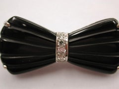 Black Onyx Diamond Bow Brooch Mounted in 9 Carat White Gold Dated circa 1930s