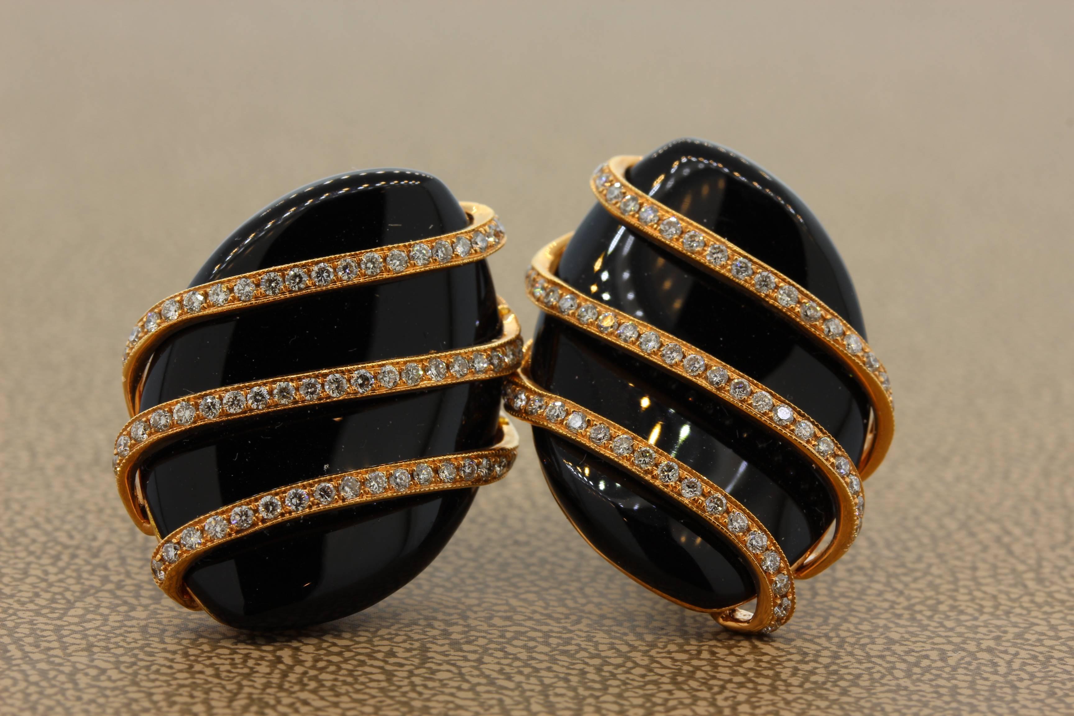 A sleek and sexy pair of onyx earrings with diamond accents. The two pieces of onyx are very lustrous and perfectly matching. They are wrapped around by diamond studded 18k rose gold. There is a lovely contrast between the black onyx, white diamonds