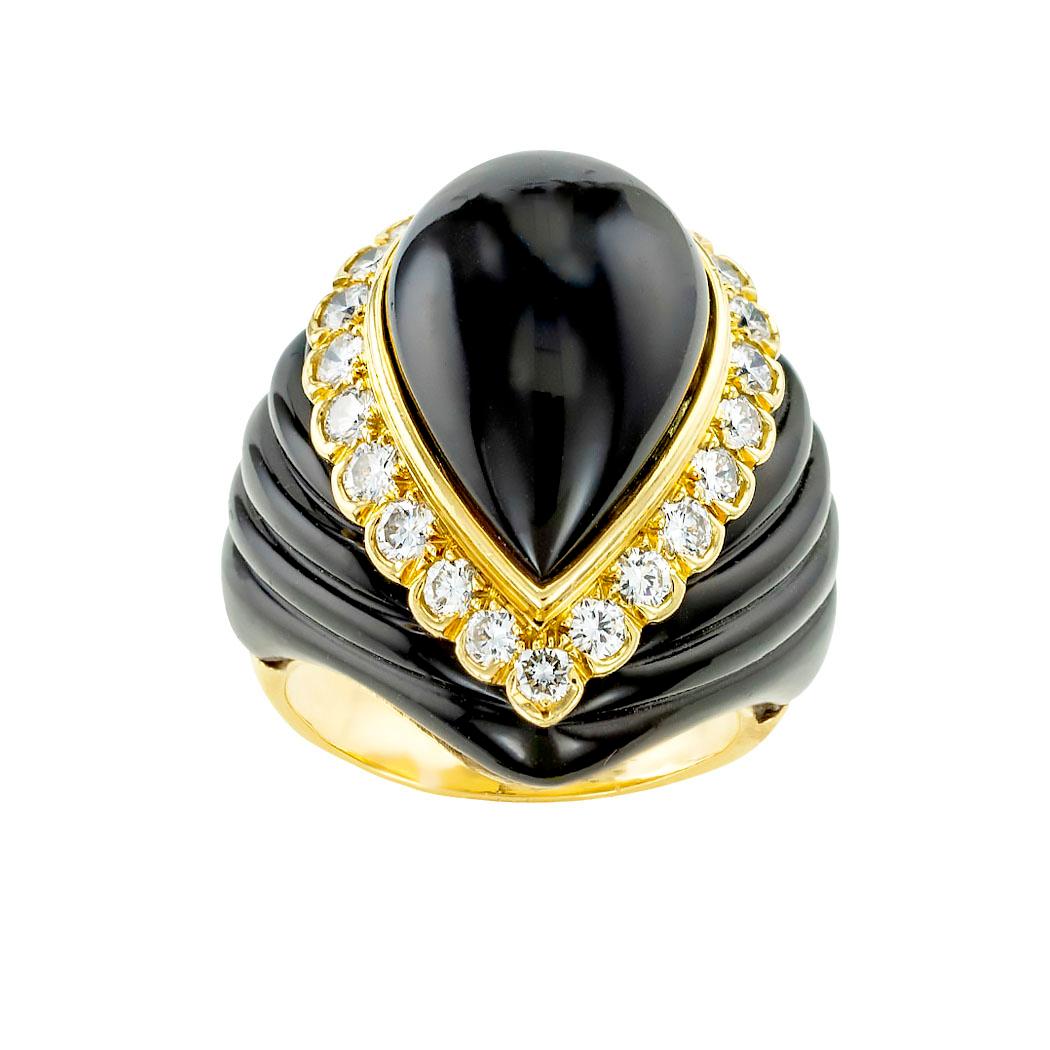 Onyx diamond and yellow gold cocktail ring by Trio circa 1990. *

SPECIFICATIONS:

GEMSTONES:  black onyx.

DIAMONDS:  twenty-two round brilliant-cut diamonds totaling approximately 1.25 carat, approximately G-H color, VS clarity.

METAL:  18-karat