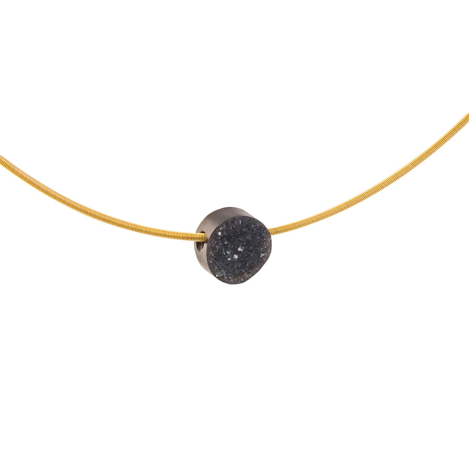 Sourced from the inside of a geode this Black Onyx Drusy gem is suspended on an 18 karat yellow gold circular style necklace. 

A geode is a hollow shell of stone, lined with crystals pointing toward the centre. Drusy is name given to the glittering