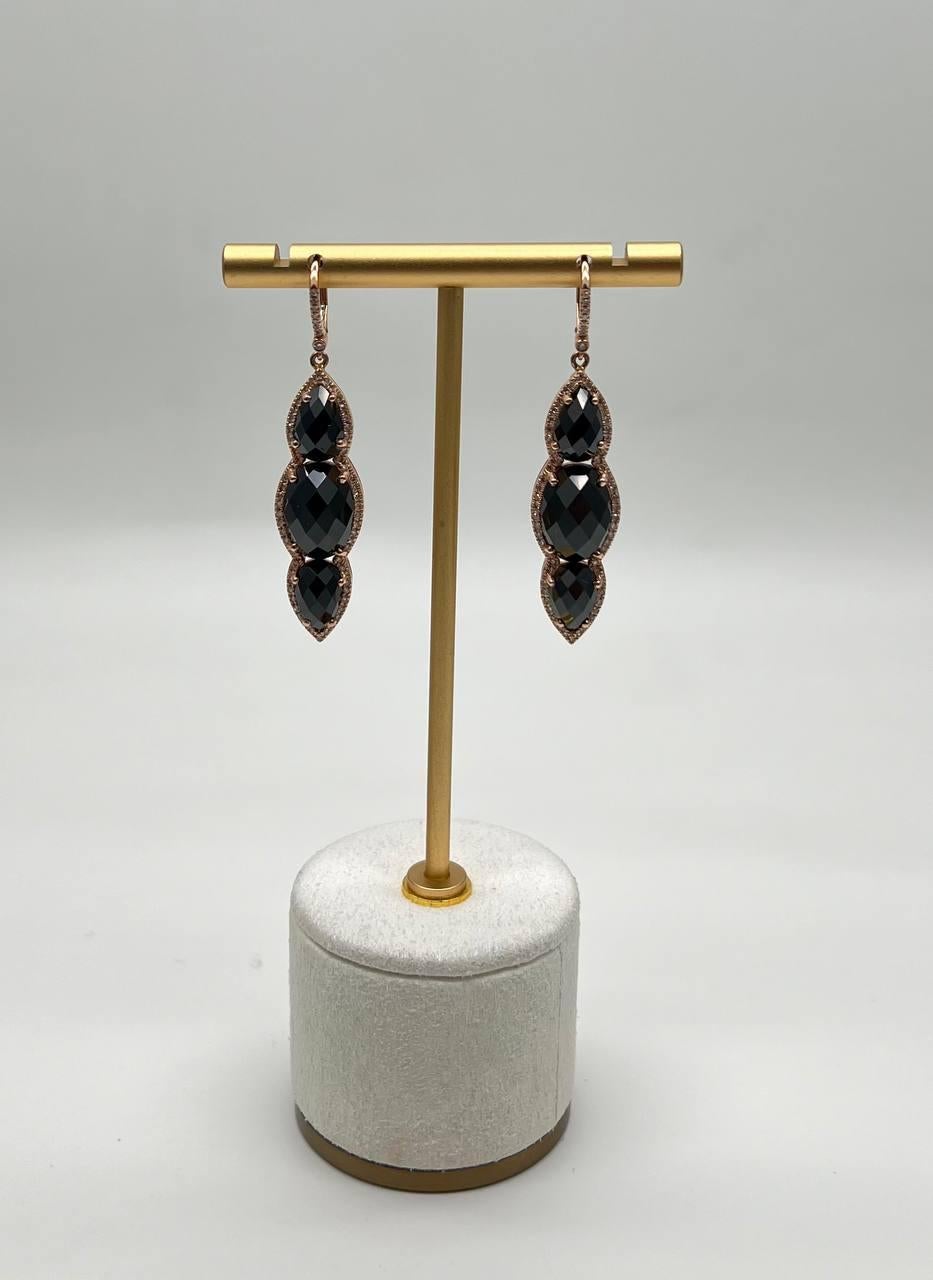 Discover the allure of our exquisite earrings, a testament to refined elegance and craftsmanship.

These captivating earrings feature a trio of faceted black onyxes, each framed delicately in 14k gold. The elongated design creates a graceful