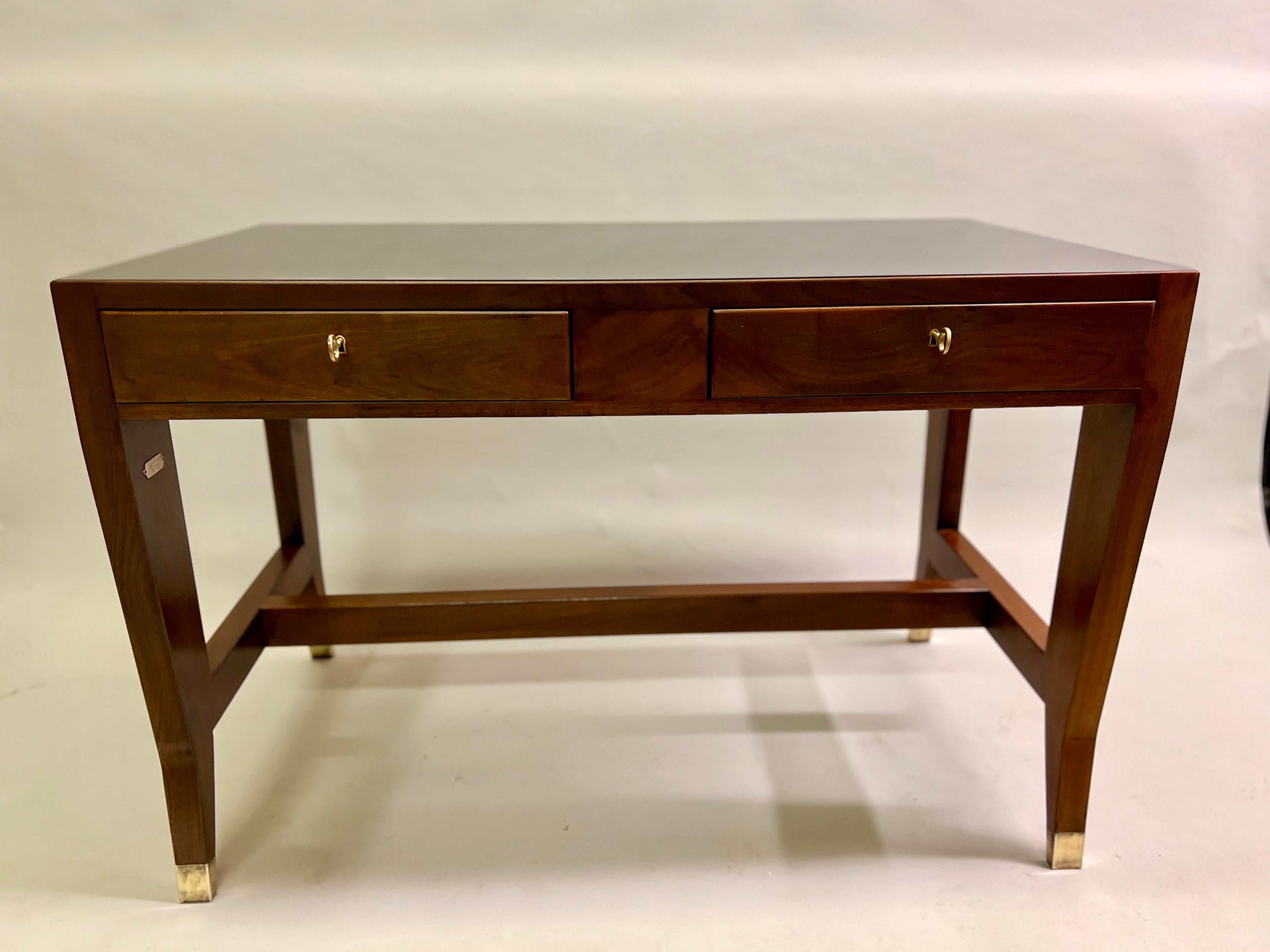A Rare and Elegant Italian MId-Century Modern Neoclassical Desk / Writing Table by Gio Ponti in solid walnut with an inset top of black onyx glass and brass details. Ponti's design acumen is powerful and sublime in this piece; the desk is a