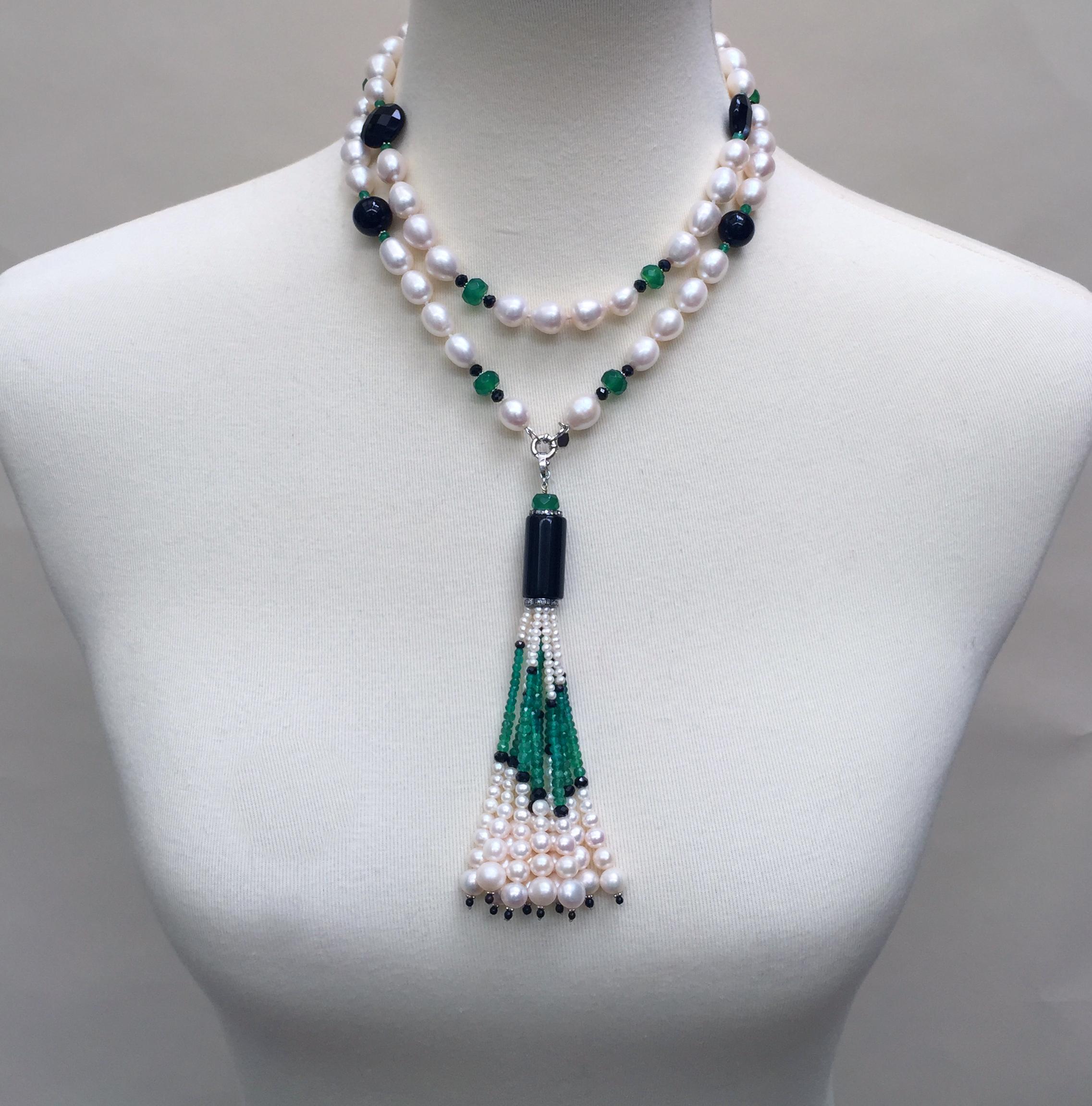 The black onyx, jade, and pearl necklace with  tassel and 14 karate white gold clasp is a beautifully handmade piece by Marina J.  The oblong pearls glow in contrast to the brilliant green jade and black onyx beads separated by small 14 k white gold