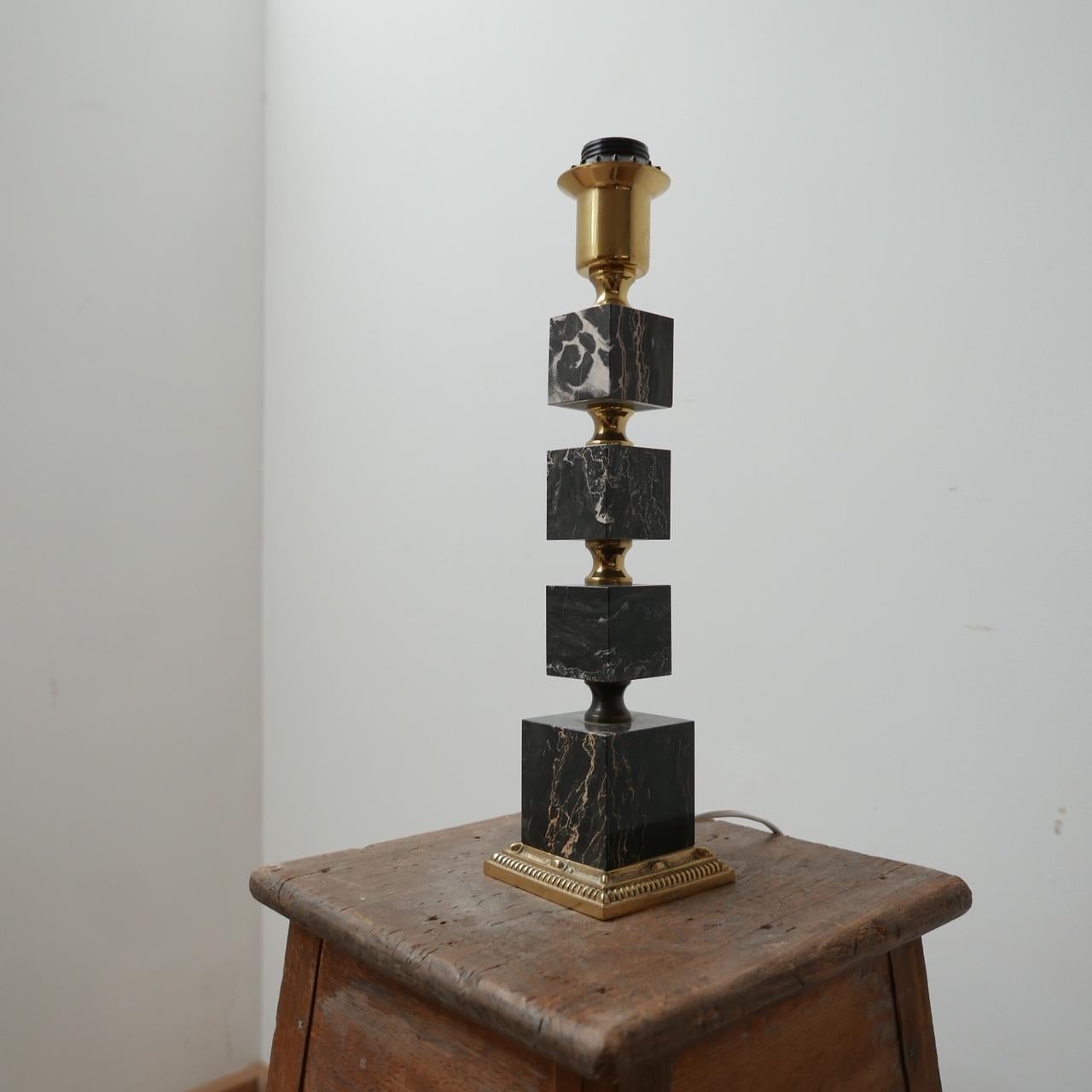 A stepped mid-century table lamp. 

Formed from different sized blocks of stone. 

Either onyx or a black marble with brass detailing. 

Re-wired and PAT tested since. 

Dimensions: 10 W x 10 D x 41 H in cm.

Delivery: POA.

 