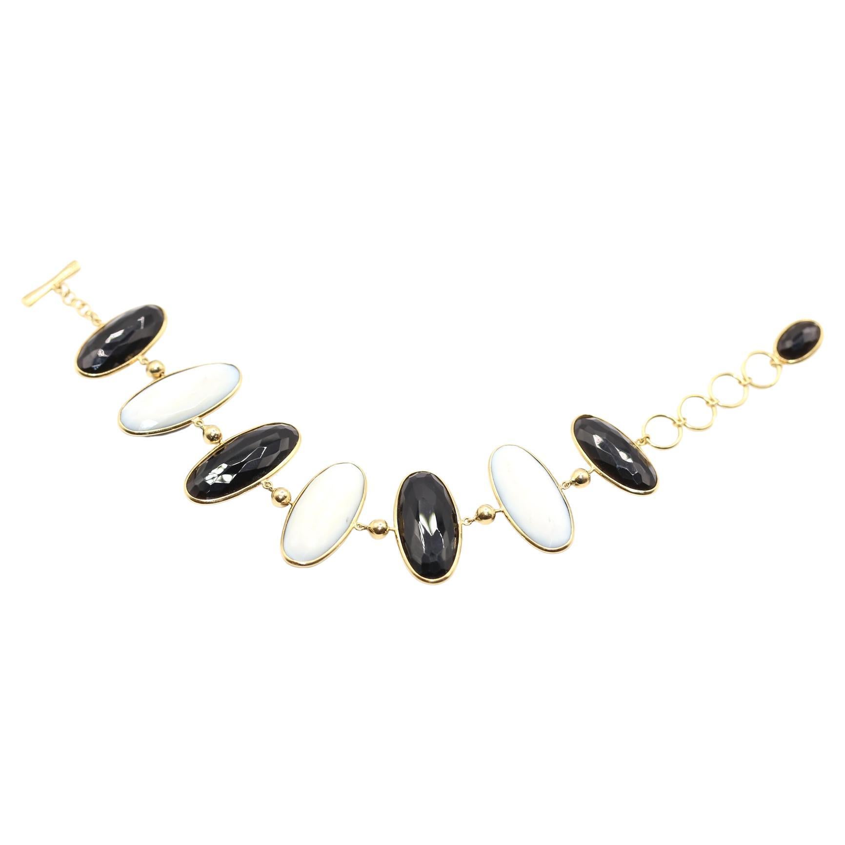 Black Onyx  and white Mother-Of-Pearl Toggle (Double Sided) Bracelet. Set in  18K Yellow  Gold. Created around  1970.

Eight double sided oval plaques of black Onyx and white Mother-of-pearl. Each one can be individually turned around.
Set in 18