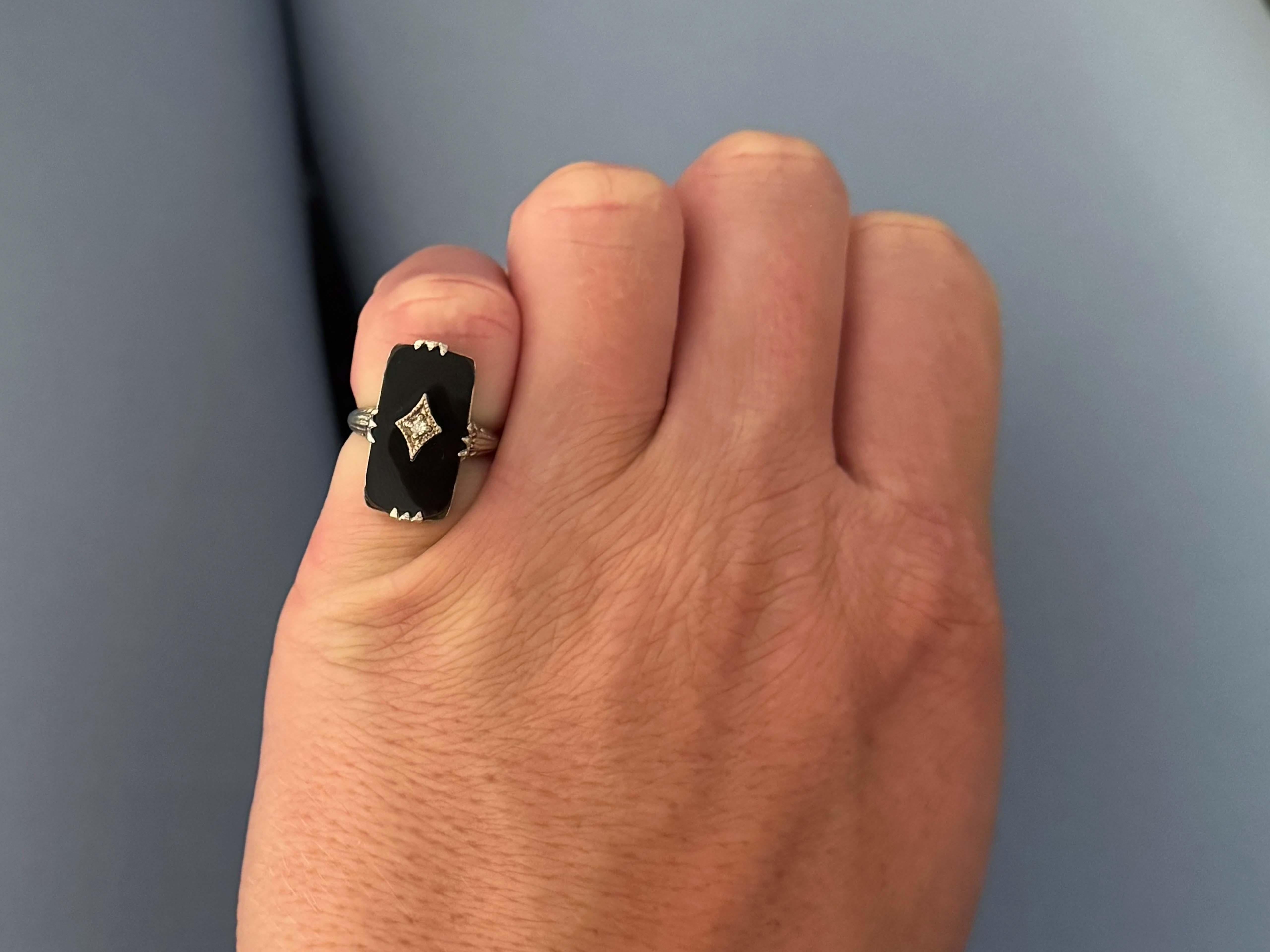 Item Specifications:

Metal: 14k White Gold
​
​Gemstone: Onyx

Diamond Count: 1 brilliant cut

Total Diamond Carat Weight: ~0.01 carats 

Diamond Color: H-I

Diamond Clarity: I1

Ring Size: 3.25 (for resizing please message us before
