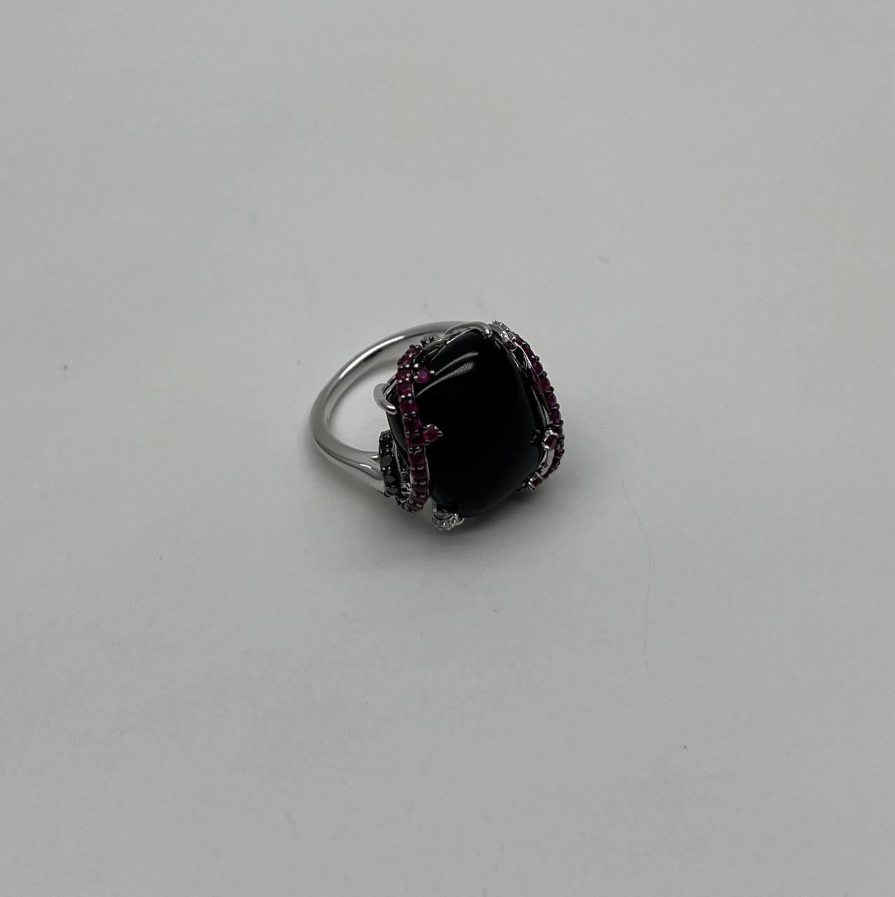 Bold and Sophisticated.
Set with a Large Black Onyx
Accented by Intricate Red Rubies Halo and Diamonds.
14K White Gold
0.30 CTW Diamonds
14.70 CTS Black Onyx & Red Pink Rubies