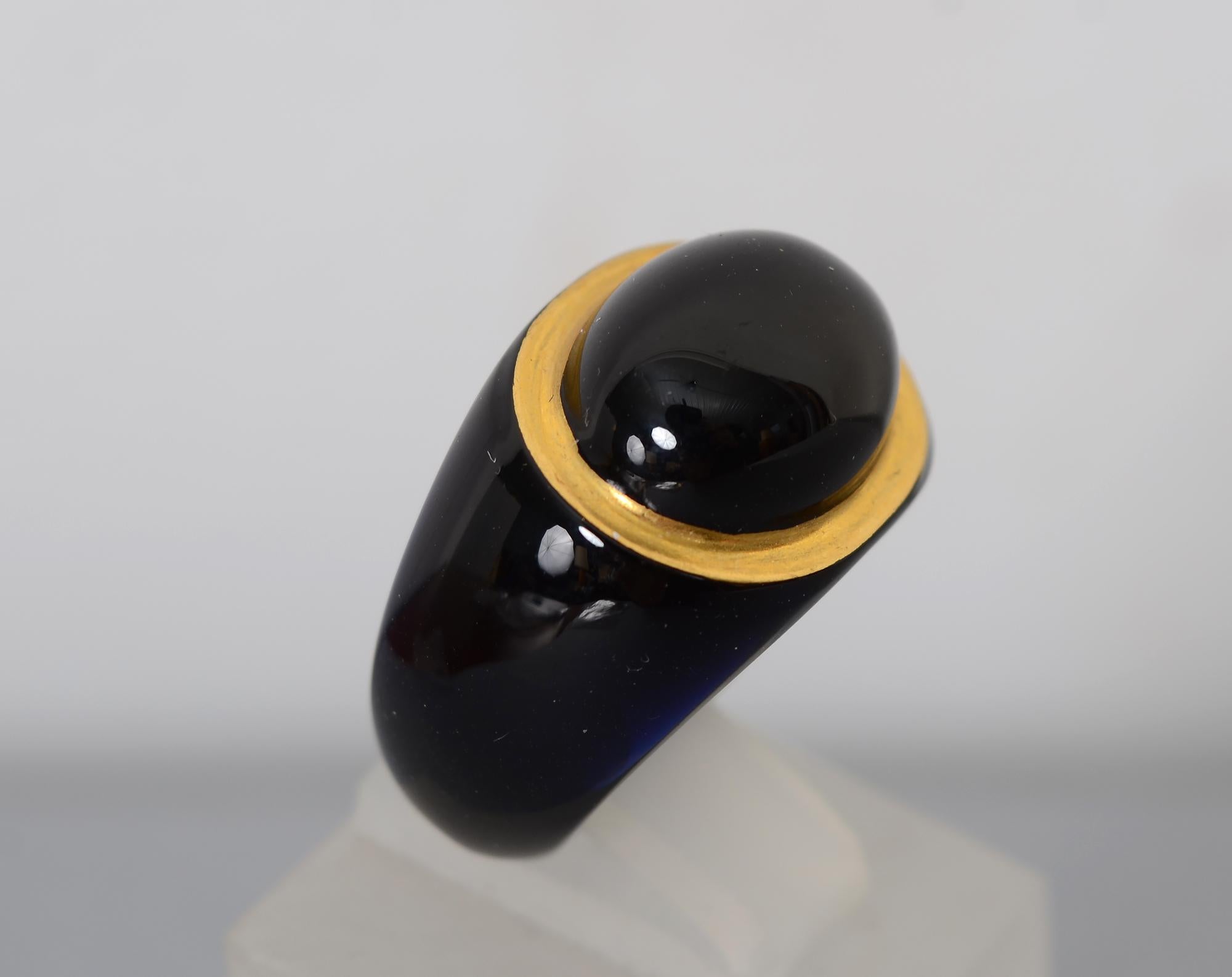 An oval black onyx stone is set in a 14 karat gold bezel in this stylish black ring. The ring is a composite material. It is size 6 1/2 and cannot be changed. The ring measures 5/8
