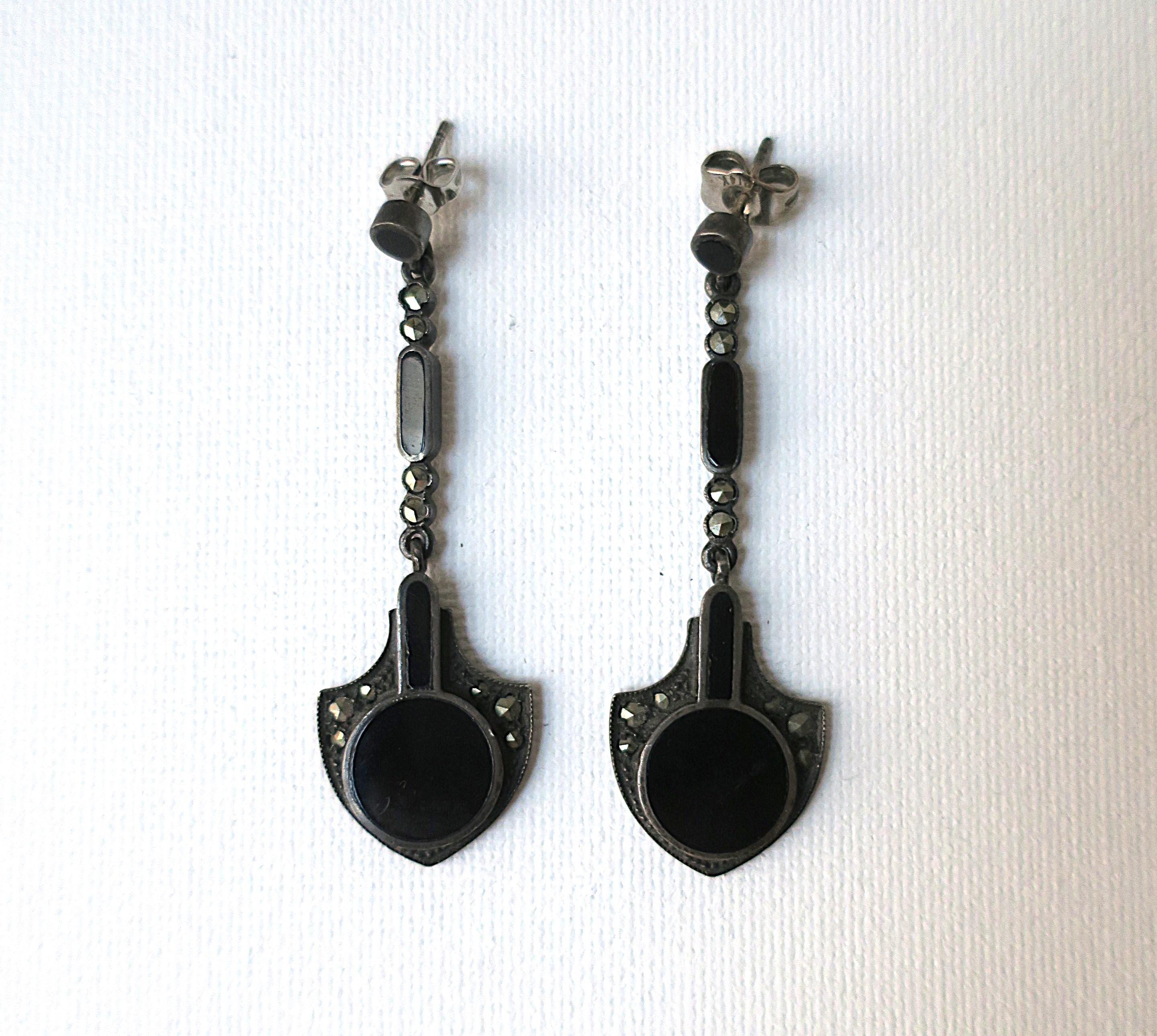 A striking pair of black onyx and sterling silver dangle drop earrings, in the Art Deco design style, circa late-20th century. A great pair to dress up or down. Marked 'Sterling' on back as shown in last image. Dimensions: .69
