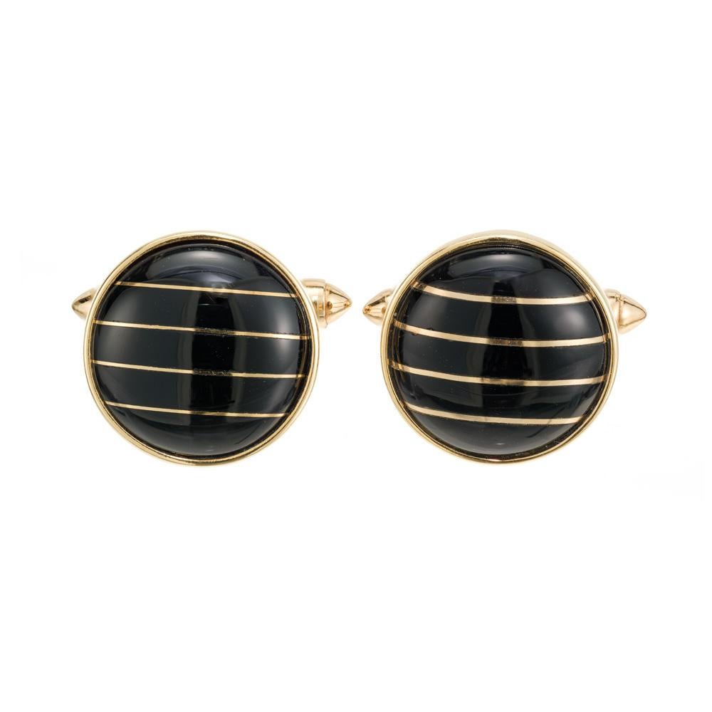 1990's domed black onyx 14k yellow gold men's cufflinks. 10 onyx slabs separated by 14k yellow gold spacers. 

10 rectangular black onyx slabs
14k yellow gold 
Stamped: 14k
9.2 grams
Top to bottom: 16.4mm or .65 Inches
Width: 16.4mm or .65