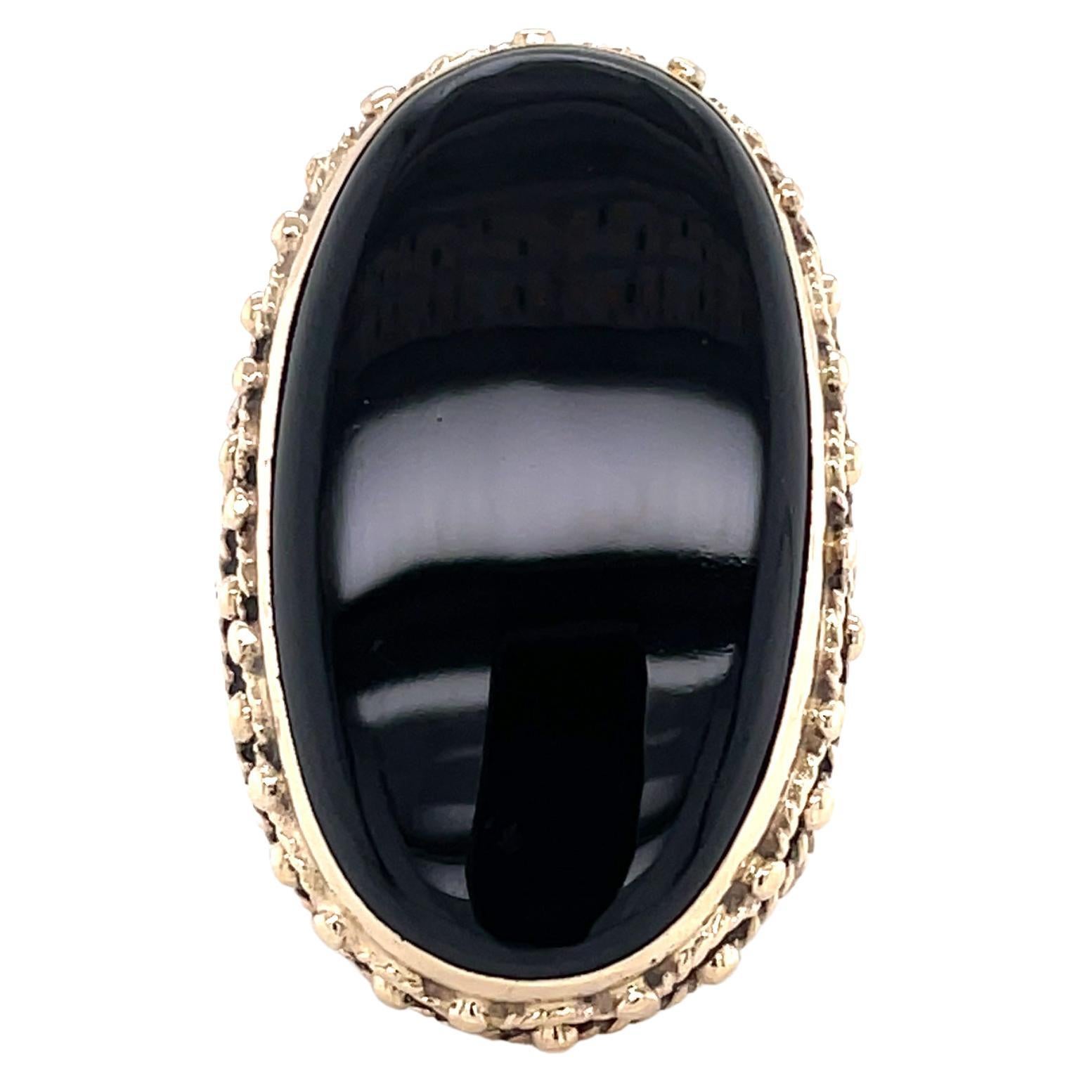 Make a bold statement with the 40 carat size and power of color exhibited by this large oval 17.5 x 30.5 mm polished black onyx stone elegantly framed in a ten karat 10K yellow gold filigree setting. In size 4.5 and resizable. Gift boxed.