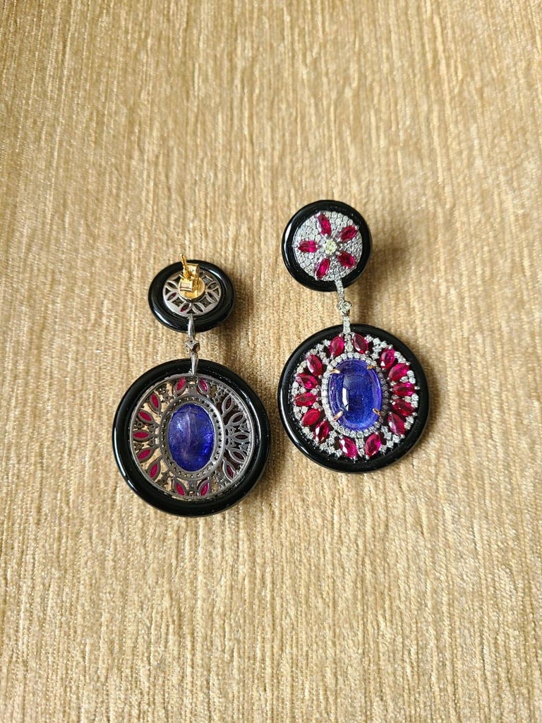 A very gorgeous and one of a kind, Black Onyx, Ruby & Tanzanite Victorian earrings set in 14K Gold, Silver and Diamonds. The weight of the Tanzanite is 16.04 carats. The weight of the Ruby is 6.00 carats. The weight of the Black Onyx is 22.46