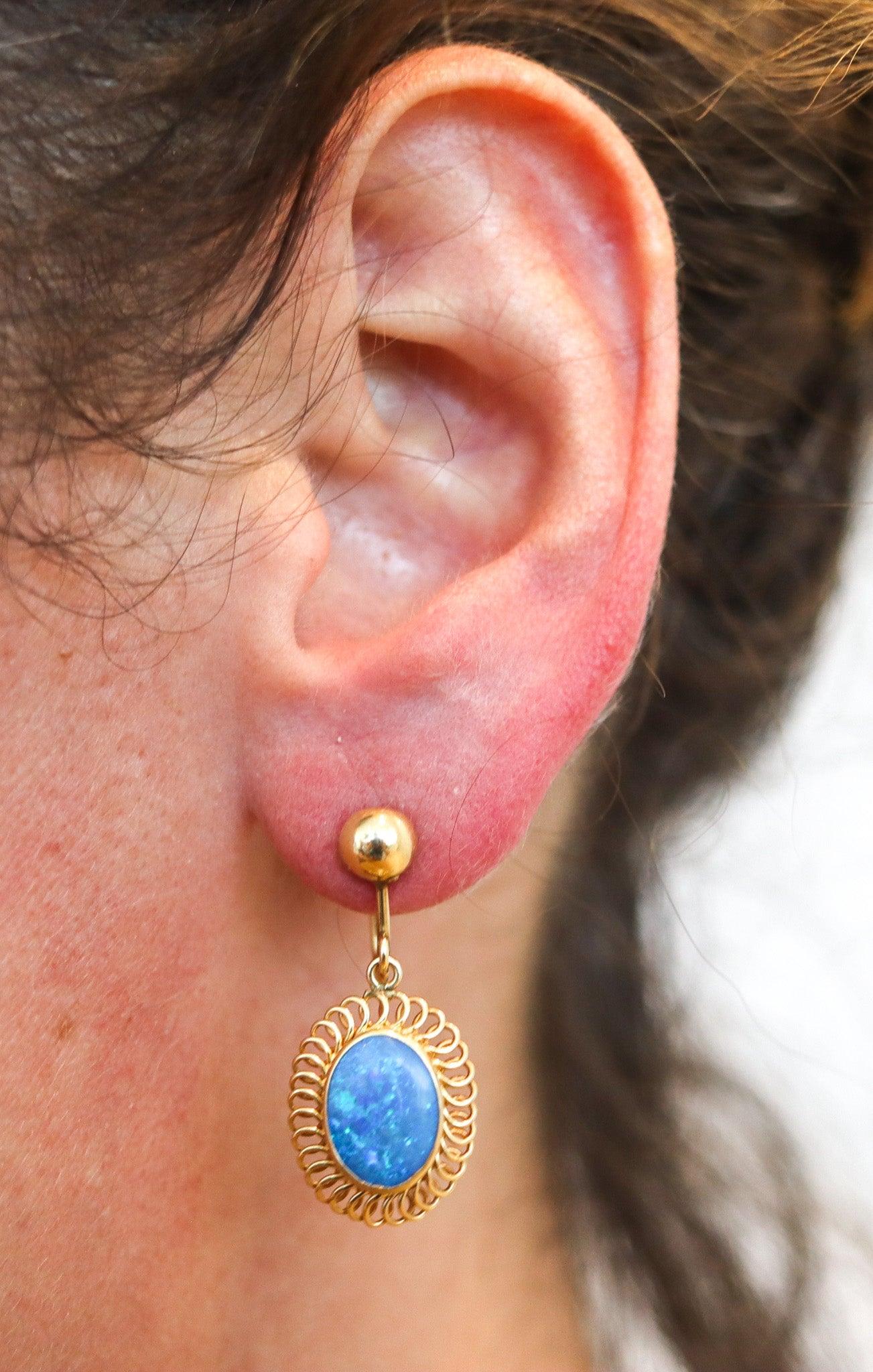Pair of vintage earrings with black opals.

This is a beautiful pair of European dangle drops earrings, most probably created in Germany, back in the late 1940's. The earrings have been crafted with twisted wires made up in solid yellow gold of 14