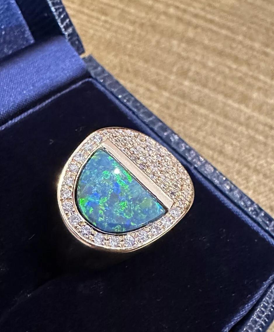 Black Opal 2.36 carat and Diamond Ring in 18k Yellow Gold 

Estate Black Opal Ring features a Half-moon shape Black Opal weighing 2.36 carats and Natural Round Diamonds pave set in High polish 18k Yellow Gold.

Total black opal weight is 2.36