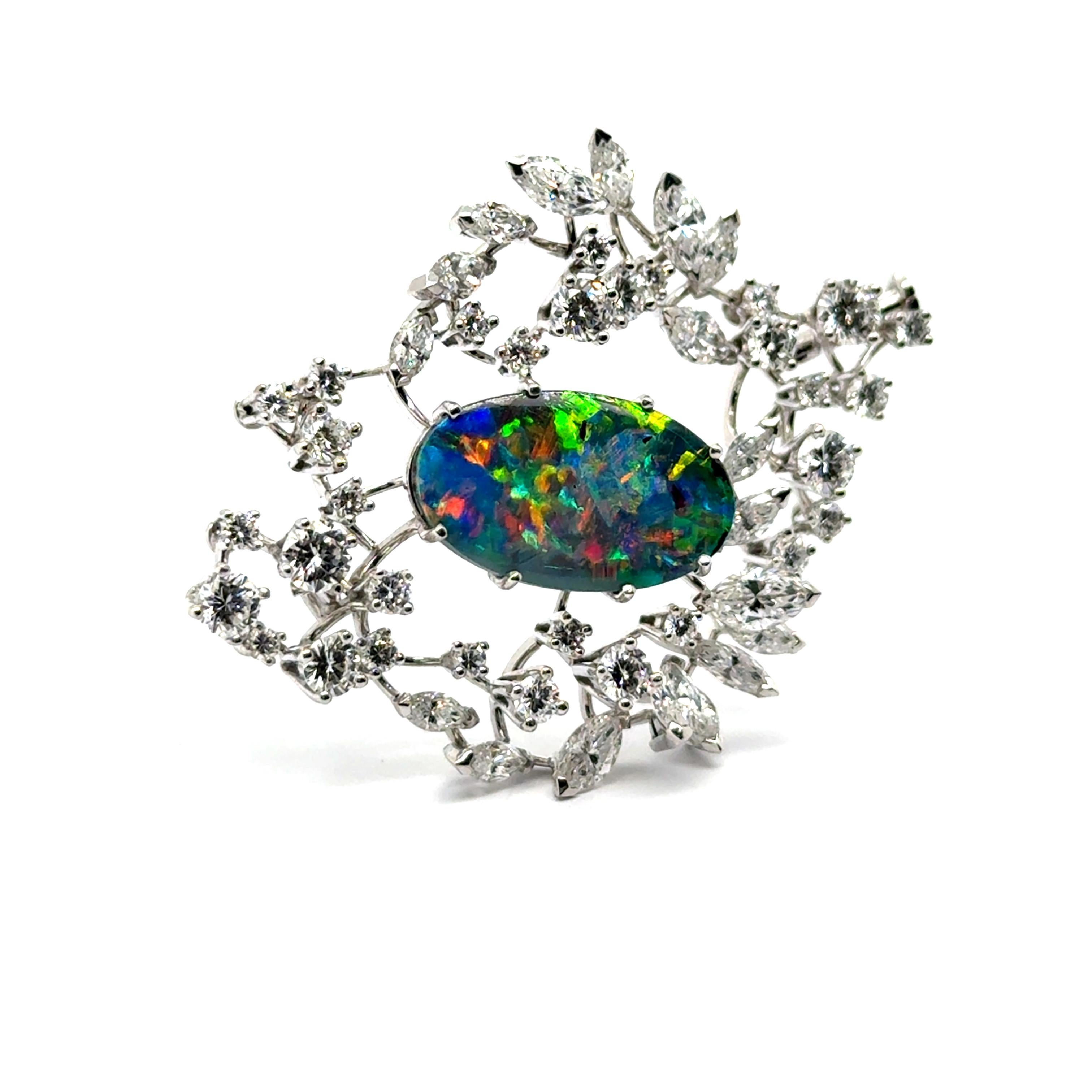 The Gübelin brooch is a masterpiece of fine craftsmanship, featuring a 3.89-carat black opal with vibrant flashes of green, blue, orange, and red. 

Set in white gold, it is surrounded by eighteen marquise-cut diamonds totaling 1.95 carats and