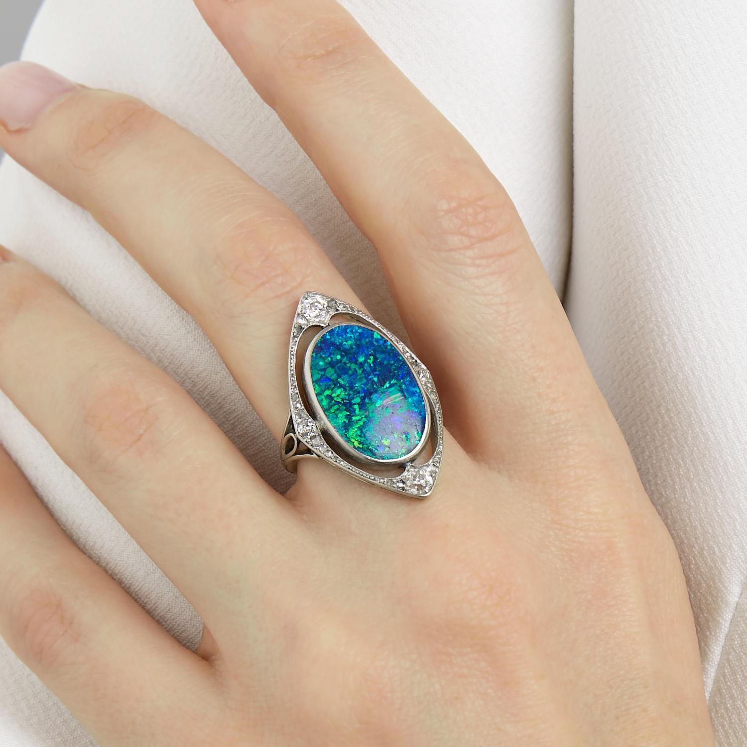 Oval black opal in a setting punctuated with small  old cut- diamonds.Platinum setting. 
Gross weight : 8,41 gr. 
Dimensions : 3 x 1,9 cm. 
Finger size : 6 1/4
French , ca. 1910
(opal approximately 6 cts)
