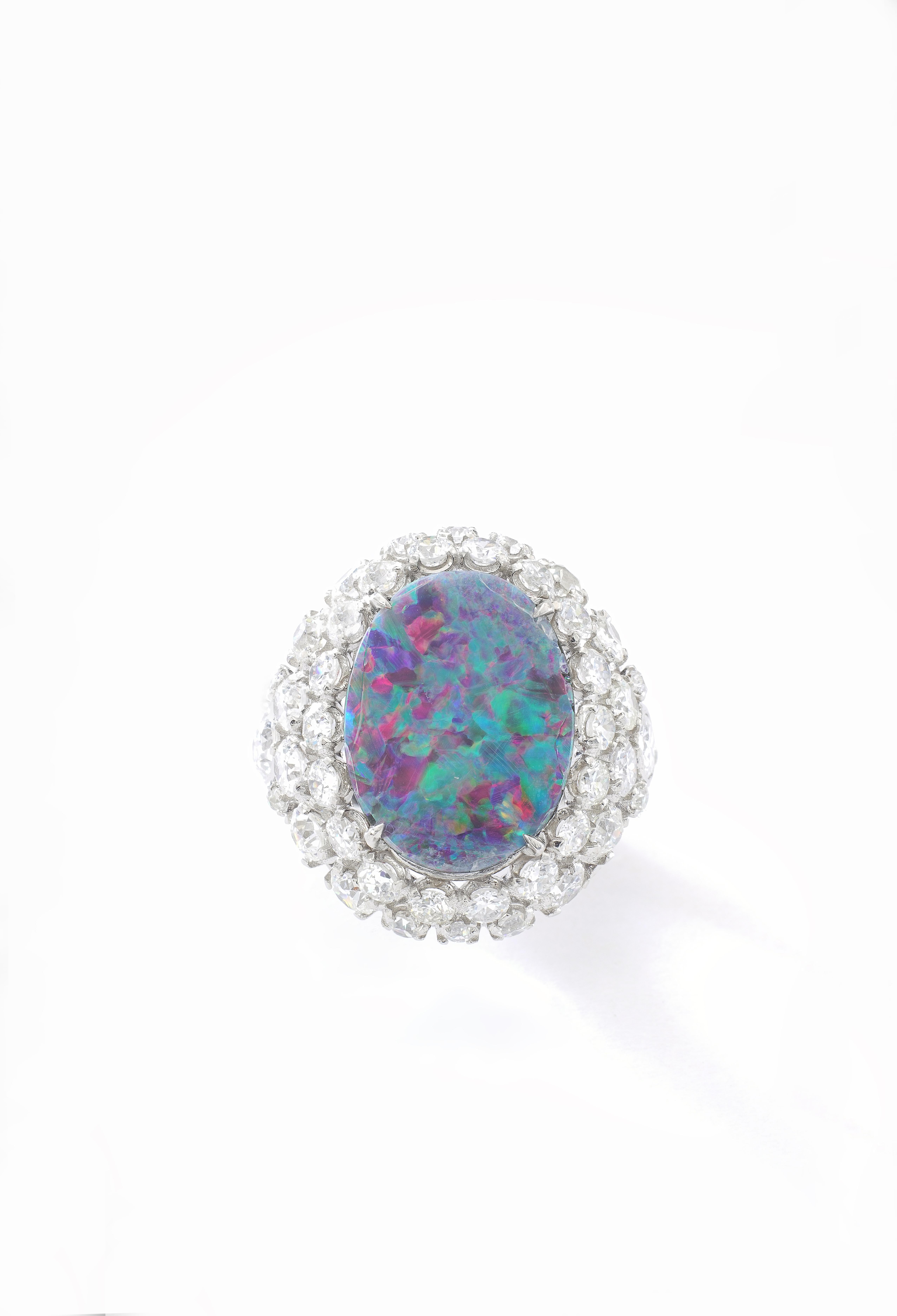Opal Black doublet surrounded by Diamond on Platinum Ring.
Size: 17.00 x13.00 millimeters.

Total Diamond weight: approximately 4.80-5.00 carats.
Estimated H color, Vs clarity.